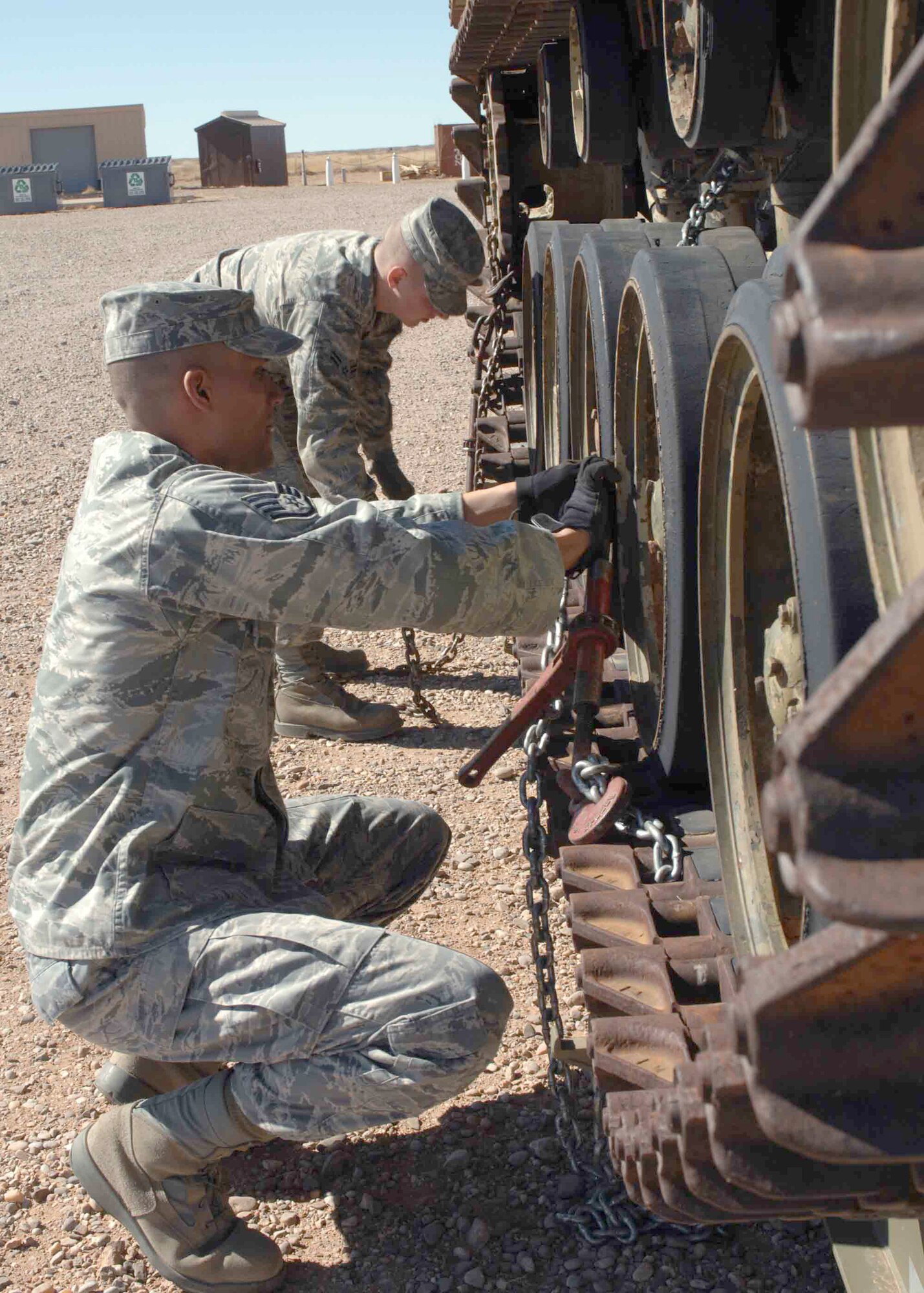 CANNON AIR FORCE BASE, N.M. -- Staff Sgt. Geraldo Valdez, 27th Special Operations Logistics Readiness Squadron, and Airman Basic Jake Jordan, 27 SOLRS, unchain an M-42 Duster tank at the Melrose Air Force Range on Feb. 18. Two tanks were donated by the Army National Guard in Clovis. One will be used as a  practice target and the other one will be set up as a static display.  (U.S. Air Force photo/Airman 1st Class James Bell)