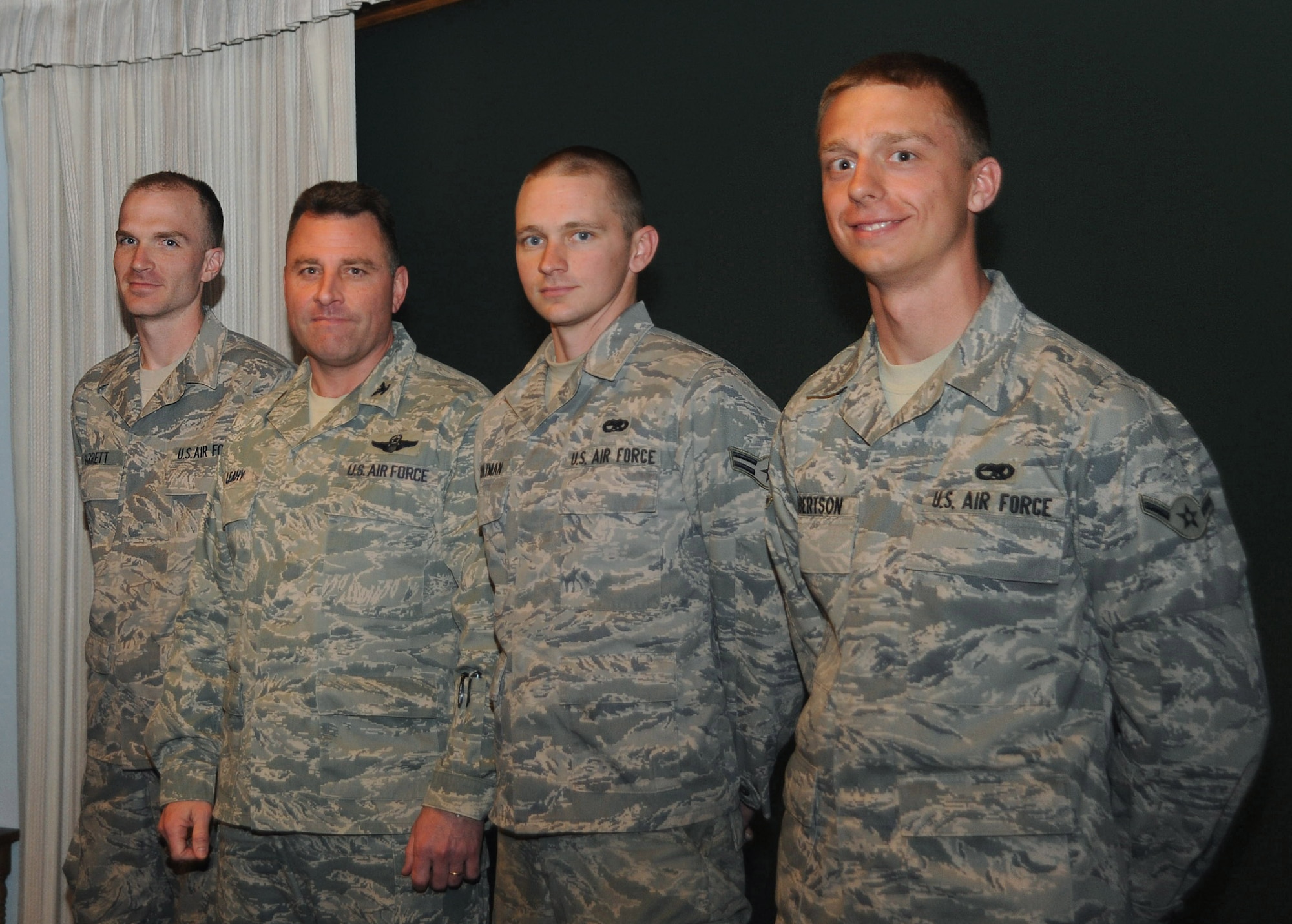 CANNON AIR FORCE BASE, N.M.?(Second from left) Col. Timothy Leahy, 27th Special Operations Wing Commander, stands among (left) Staff Sgt. Nolan Garret, (third from left) Airman 1st Class Michael Chatman, and (right) Airman Edward Robertson, 27th Special Operations Aircraft Maintenance Squadron Feb. 6 in the wing conference room. The Airmen received commander?s coins after, with the support of fellow 27 SOAMXS personnel, launching a 73rd Special Operations Squadron MC-130W Combat Spear under a ?black letter initial? which meant that the aircraft flew with absolutely no discrepancies at all. (U.S. Air Force photo by Airman 1st Class Maynelinne De La Cruz)