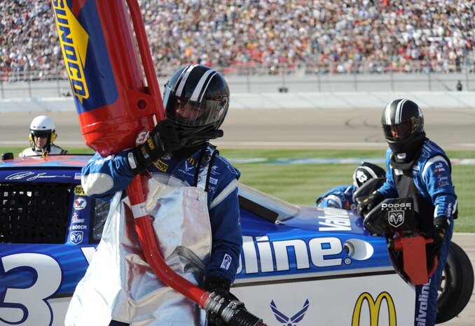 Jeff Seaberg, a transport driver/catch can for number 43 Richard Petty Motorsports, hustles after a pit stop at the Las Vegas Motor Speedway during the Shelby 427 NASCAR Sprint Cup race on March 1. Reed Sorenson, driver of the number 43 dodge charger, is sponsored by the U.S. Air Force and finished 34th in the race. (U.S. Air Force Photo/Senior Airman Larry E. Reid Jr., Released)
