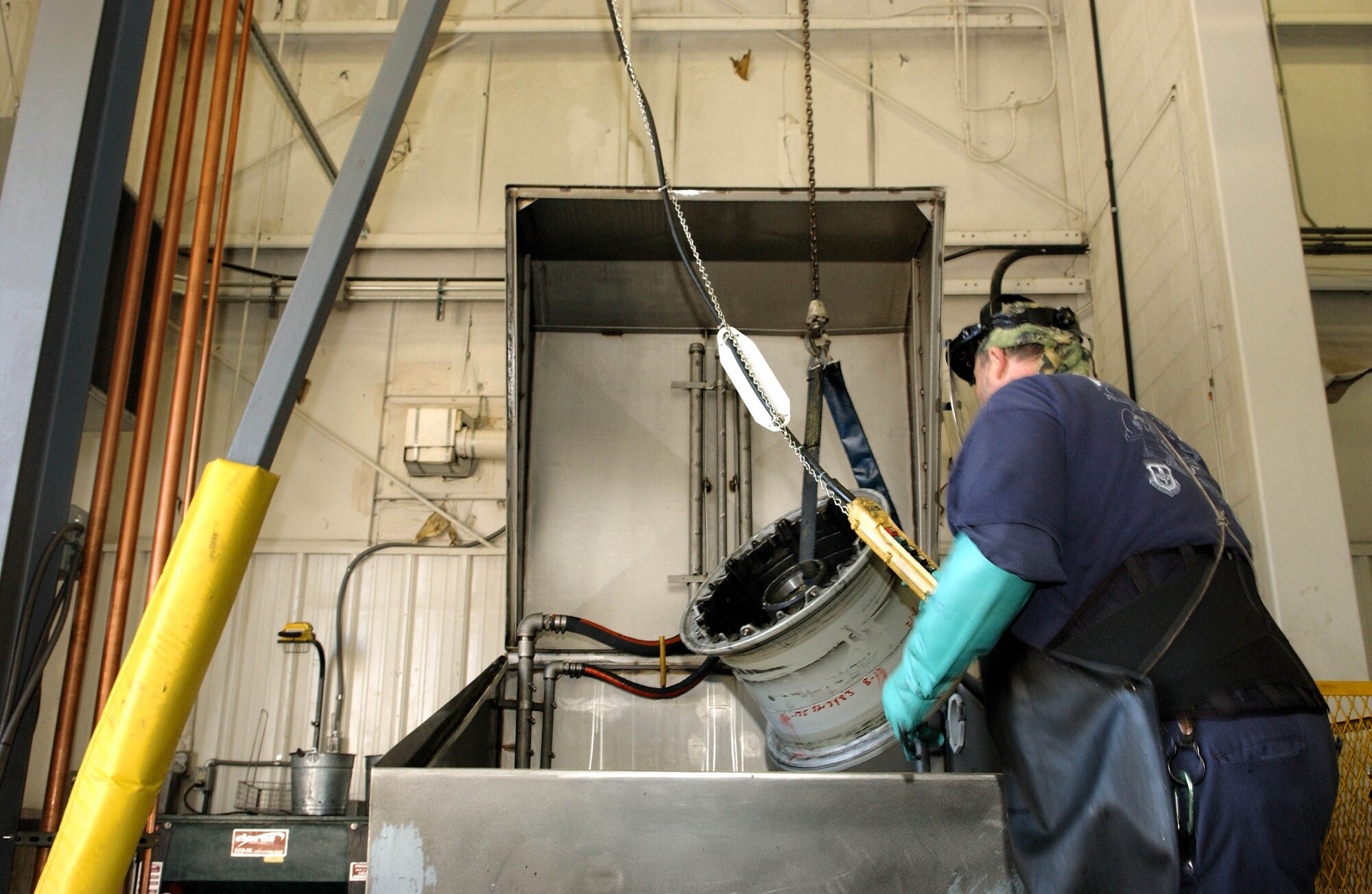 Kent Reitenour prepares a KC-135 Stratotanker wheel to be cleaned in an automated wheel washer. After the washing tire, the hazardous waste material is piped to a newly implemented environmentally friendly waste water treatment system. The system has reduced the amount of exported waste from more than 27,000 pounds to less than 10 pounds annually. The water cleaning system uses bio media to consume the hazardous waste, which in turn creates a reusable supply of cleaning water. The new system will save the 97th Air Mobility Wing more than $47,500 per year. Mr. Reitenour is a 97th Maintenance Directorate wheel and tire shop mechanic. (U.S. Air Force photo/Airman 1st Class Leandra D. Hernandez)