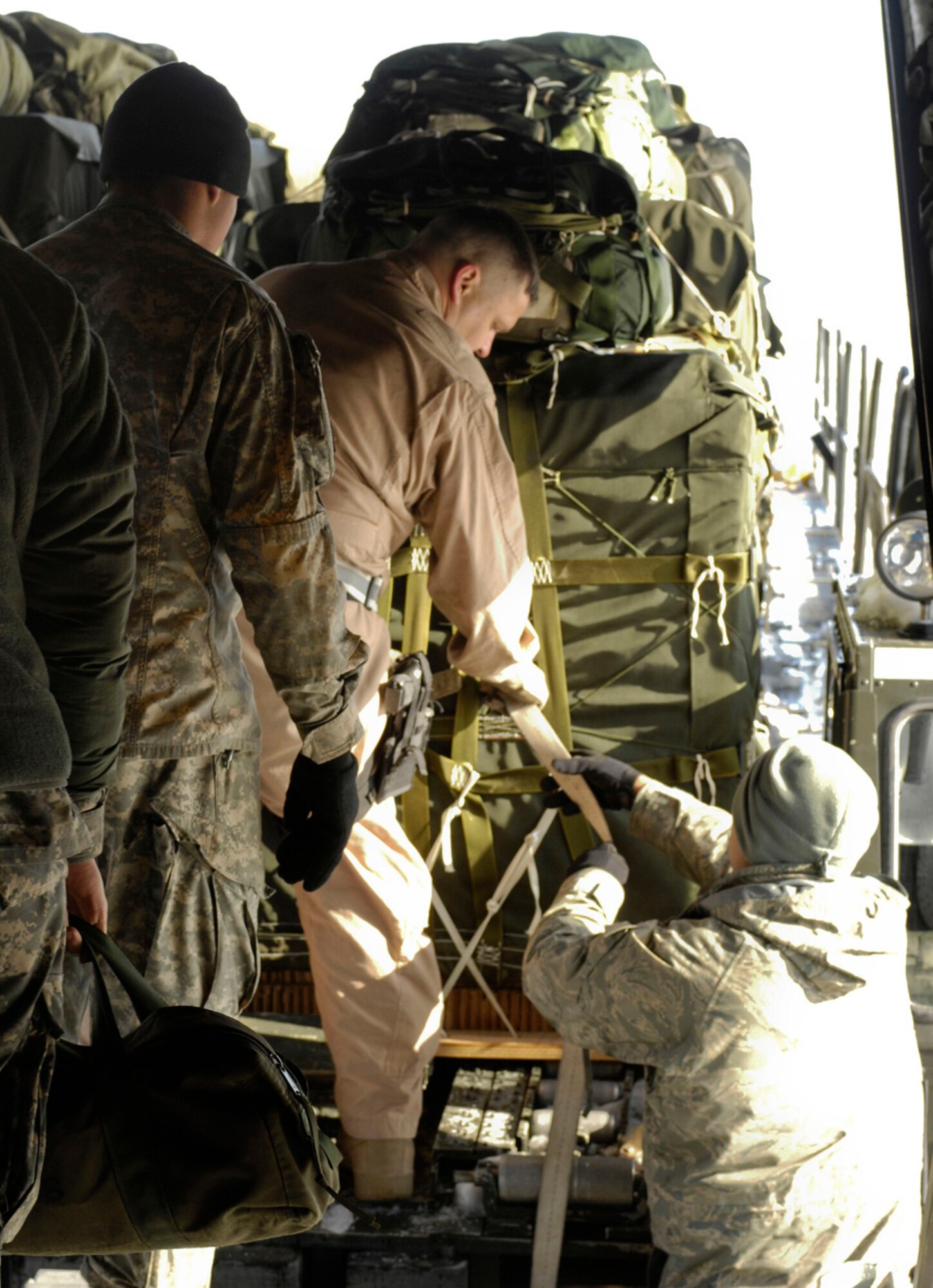 Crew chiefs from the 774th Expeditionary Airlift Squadron, Bagram Air Field, Afghanistan, offload air drop bundles from a C-130H Hercules following a mission cancellation. The bundles contained more than 17,000 pounds of food intended for U.S. troops deployed to a forward operating base in southern Afghanistan. A conventional air drop delivers cargo to a drop zone by using forecasted winds along with surface wind and altitude winds to calculate a release point.  ?Anytime we can use conventional methods to drop it keeps us from passing the drop zone twice which gives the enemy less time to react,? said Capt. Ricardo Bravo, Joint Precision Air Drop System subject matter expert deployed from Little Rock Air Force Base, Ark. (U.S. Air Force photo by Maj. Carie A. Parker) 
