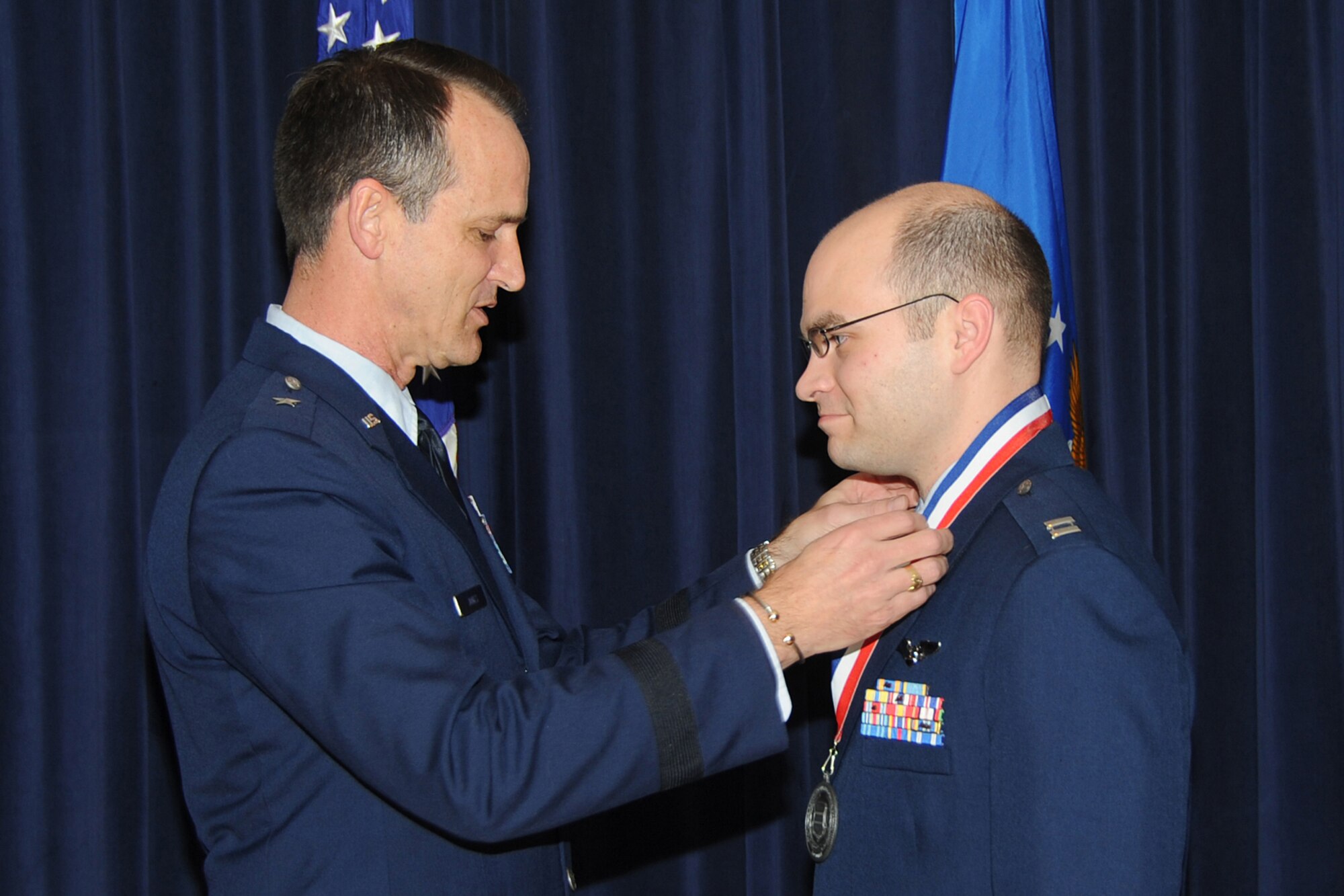 OFFUTT AIR FORCE BASE, Neb. -- Brig. Gen. James Jones, 55th Wing commander, places a medal over the head of Captain David Bonn of the 55th Operatons Group for the 55th Wing Annual Awards Medallion Ceremony at the Patriot Club Feb. 26th. The ceremony honor those nominated for the wing's annual awards.


U.S. Air Force Photo by Jeff Gates