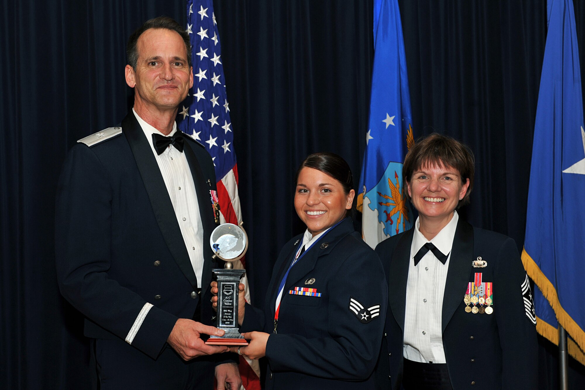 OFFUTT AIR FORCE BASE, Neb. -- Brig. Gen. James Jones, 55th Wing commander, and Chief Master Sgt. Lisa Sirois, 55th Wing command chief, congratulate Airman 1st Class Camber Valdes, 55th Mission Support Group, for winning Airman of the Year during the Annual Awards Banquet held at the Patriot Club Feb. 27. Members of the 55th Wing came together to honor those who have demonstrated tireless dedication, faithful service and excelled in the past year representing the best of the best according to the general.

U.S. Air Force Photo By Charles Haymond