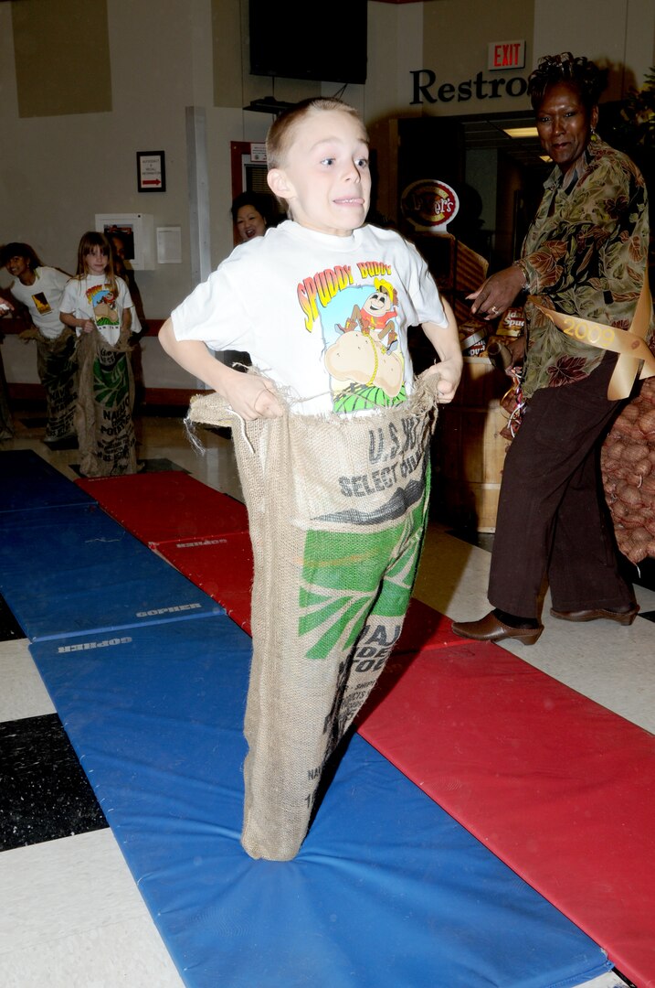James Tucker, a Randolph Elementary third grade student, eyes the prize in a potato sack race at the base commissary Feb. 27. The race, held to celebrate Idaho Potato Month, wraps up a month-long display contest held by commissaries nationwide. Each participant received a $50 Army and Air Force Exchange Service gift card. (U.S. Air Force photo by David Terry)