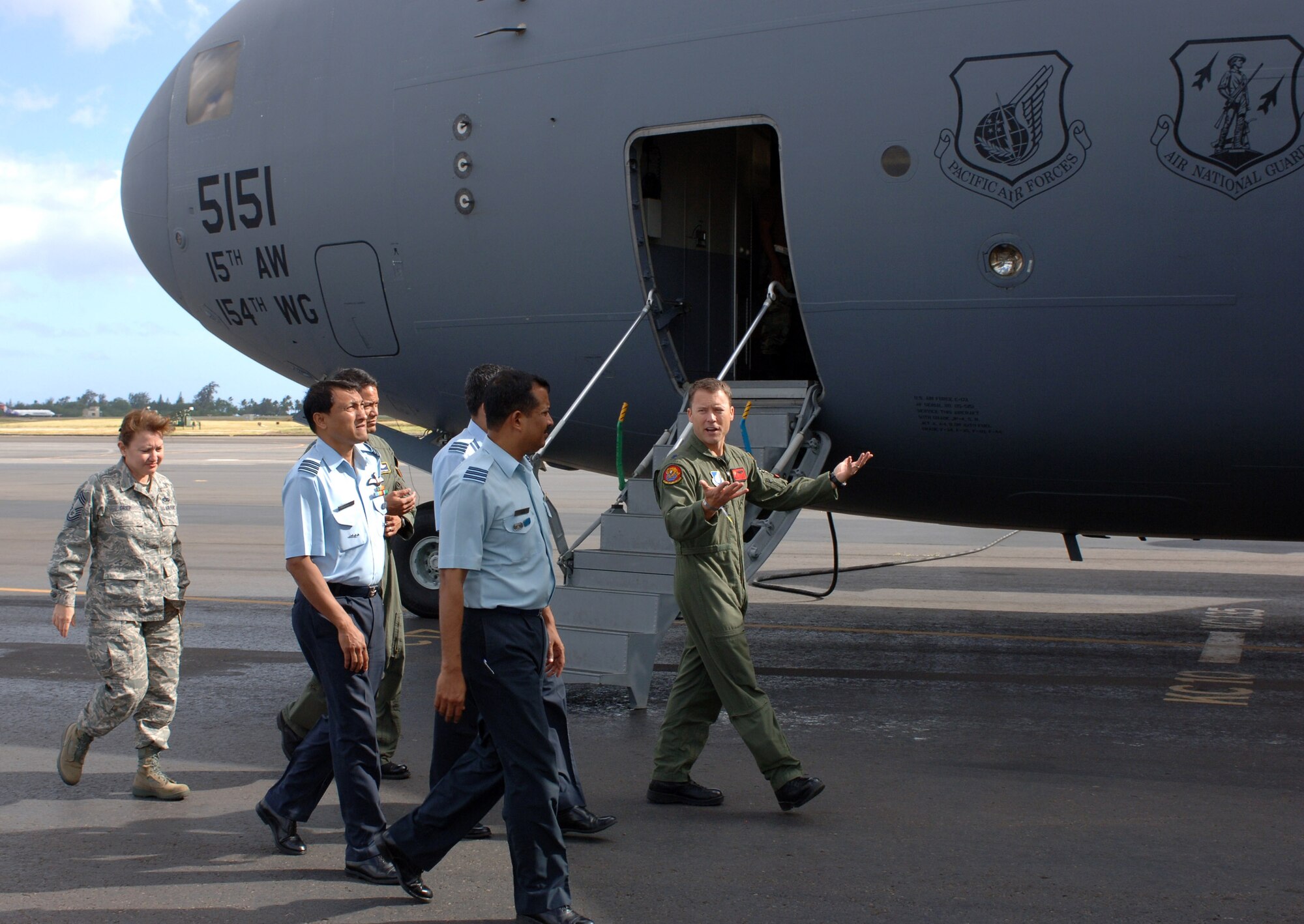 Lt. Col. Casey Eaton explains the capabilities of the C-17 Globemaster III to Indian air force wing commanders Anup Kumar Dutta, KV Surendran Nair and SK Vidhate during their Feb. 25 visit to Hickam Air Force Base, Hawaii. Members of the 613th Air and Space Operations Center at Hickam AFB hosted the visit Feb. 23 through 27, during which the Indian air force officers learned how the United States commands and controls airpower in the Pacific through the 613th AOC. Five 613th AOC members will visit India March 9 through 13 for a similar orientation, as part of a subject-matter expert exchange with the Indian air force. Colonel Eaton is the 535th Airlift Squadron commander.(U.S. Air Force photo/Oscar Hernandez) 
