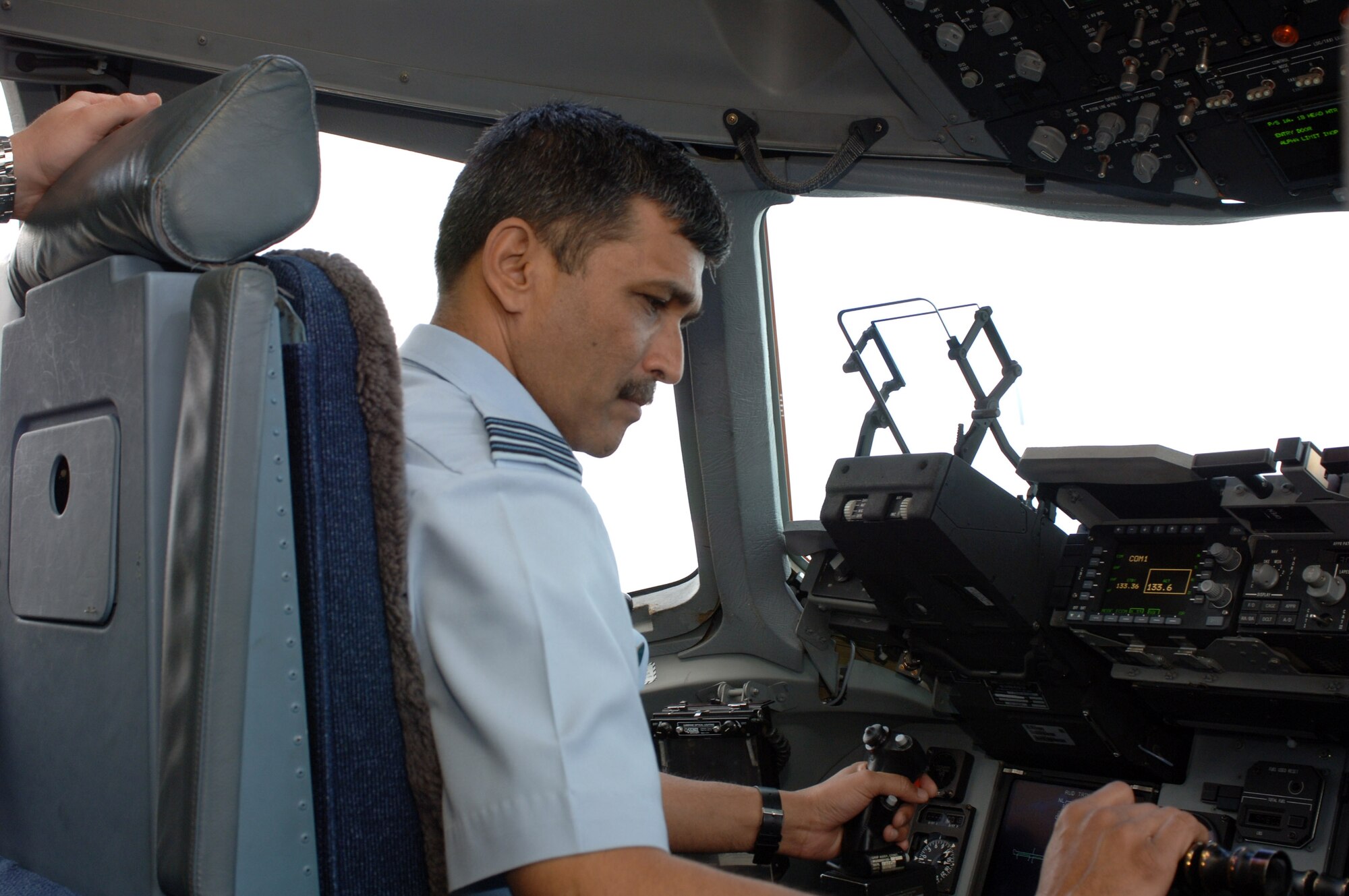Indian air force Wg. Cdr. SK Vidhate sits in the cockpit of a C-17 Globemaster III while visiting with the 535th Airlift Squadron Feb. 25 at Hickam Air Force Base, Hawaii. Members of the 613th Air and Space Operations Center at Hickam AFB hosted the visit Feb. 23 through 27, during which Indian air force officers learned how the United States commands and controls airpower in the Pacific through the 613th AOC.  (U.S. Air Force photo/Oscar Hernandez) 
