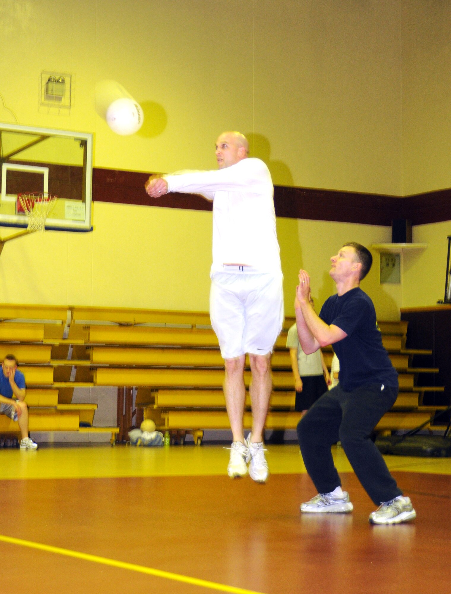 Jonathan Porter, Armed Forces Network team, jumps up to bump the ball during a late-night volleyball game, Feb. 27, at the Incirlik Fitness Center. Team Tamum Monkey Bunch won with a score of 25-13. The game took place as an athletic alternative to other late-night weekend activities. (U.S. Air Force photo by Senior Airman Heather Stanton)
