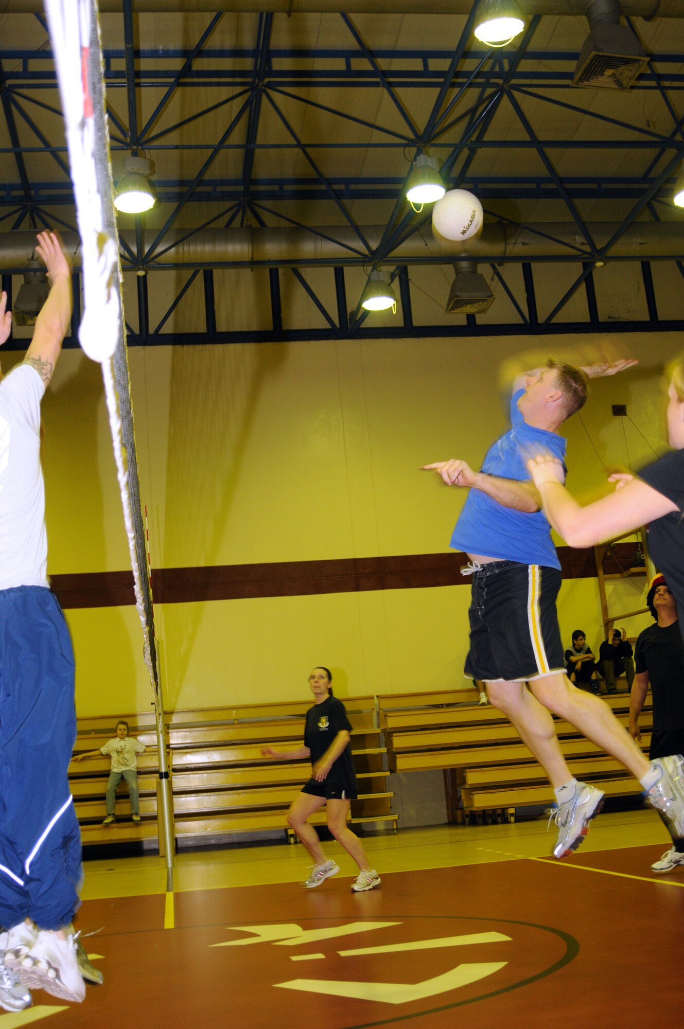 Jason Allen, Team Tamum Monkey Bunch, goes to spike the ball over the net during a late-night volleyball game against the Armed forces Network team, Feb. 27, at the Incirlik Fitness Center. Team Tamum Monkey Bunch won 25-13. The game took place as an athletic alternative to other late-night weekend activities. (U.S Air Force photo by Senior Airman Heather Stanton)
