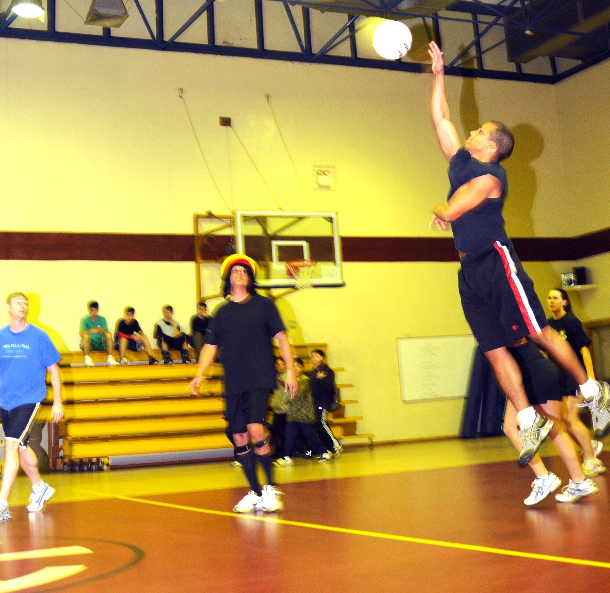Adanzy Hart, Team Tamum Monkey Bunch, goes to spike the ball over the net during a late-night volleyball game against the Armed forces Network team, Feb. 27, at the Incirlik Fitness Center. Team Tamum Monkey Bunch won 25-13. The game took place as an athletic alternative to other late-night weekend activities. (U.S Air Force photo by Senior Airman Heather Stanton)