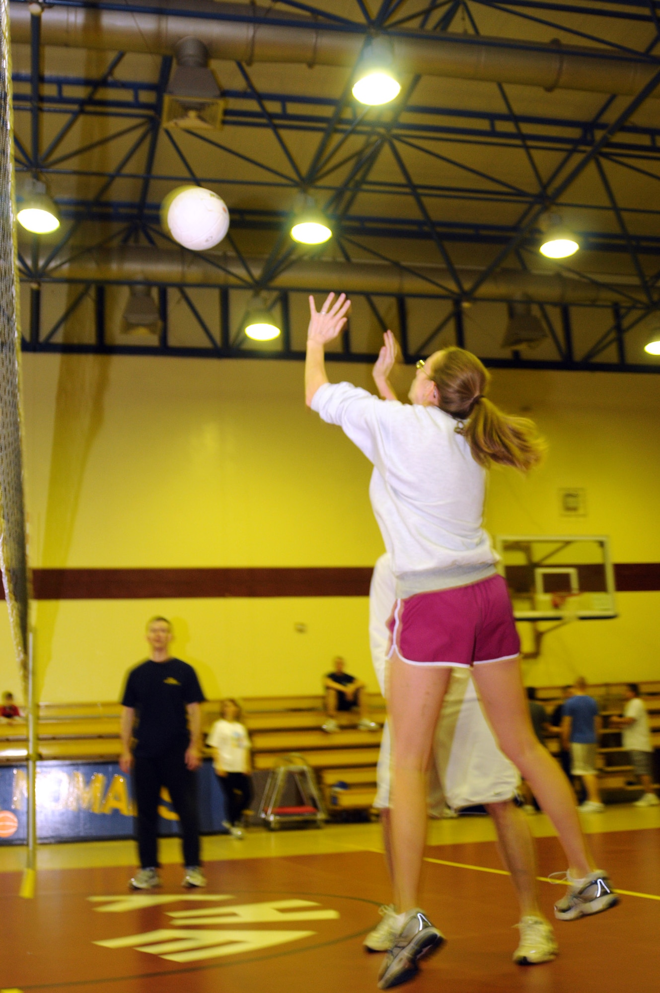 Jennifer Stai, Armed Forces Network volleyball team, goes up to set the ball during a late-night volleyball game against Team Tamum Monkey Bunch, Feb. 27, at the Incirlik Fitness Center. Team Tamum Monkey Bunch won with a score of 25-13. The game took place as an athletic alternative to other late-night weekend activities. (U.S. Air Force photo by Senior Airman Heather Stanton)