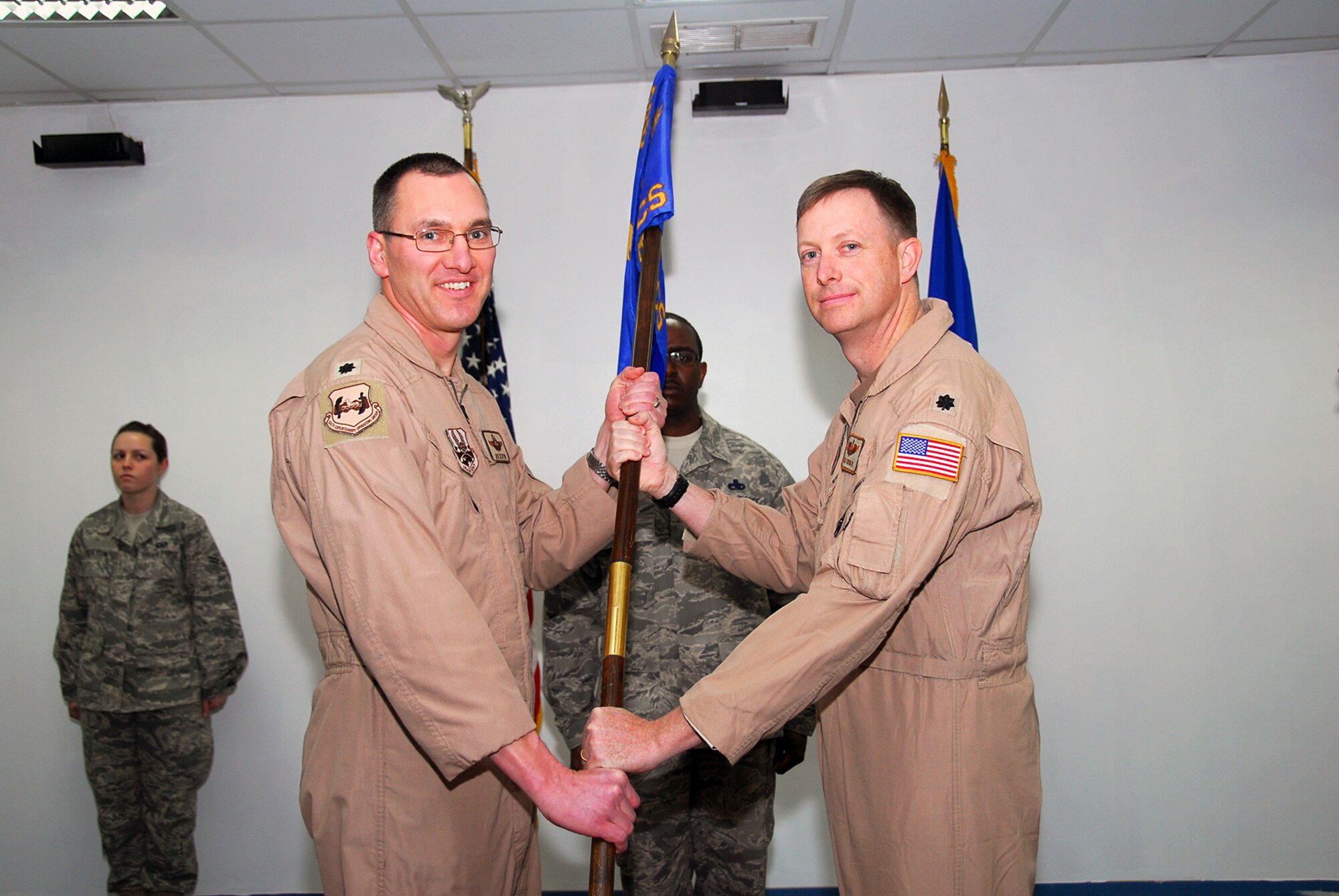SOUTHWEST ASIA -- Lt. Col. Joseph Sexton, 386th Expeditionary Operations Group deputy commander, gives command of the 386th Expeditionary Electronic Combat Squadron to Lt. Col. Kyle Forrer during a change of command ceremony at an air base in Southwest Asia March 2. Colonel Forrer is deployed from Davis-Monthan Air Force Base, Airz. (U.S. Air Force photo by Senior Airman Courtney Richardson)