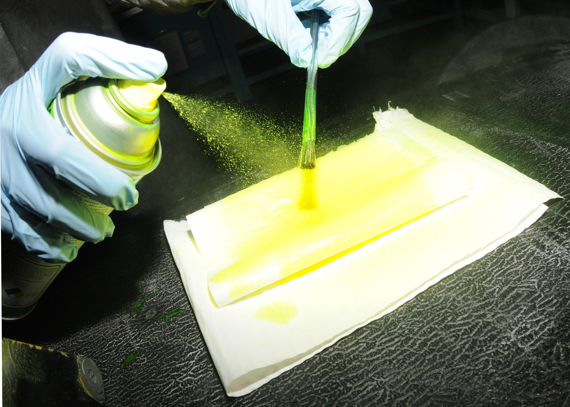 SPANGDAHLEM AIR BASE, Germany – A brush is sprayed so that penetrant can be applied to egress parts, Feb. 23, 2009 in the equipment maintenance shop. (U.S. Air Force photo by Airman 1st Class Nicholas Wilson)
