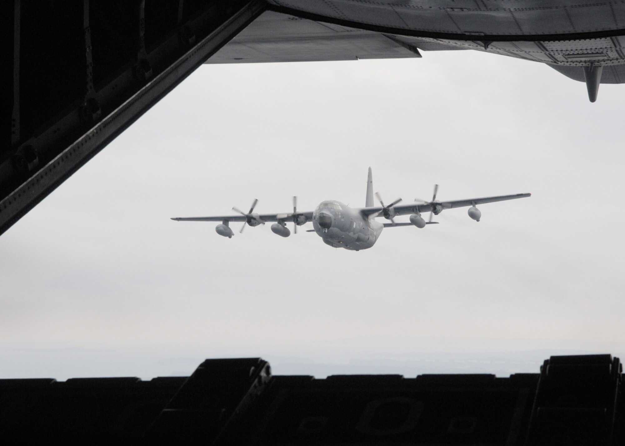 KADENA AIR BASE, Japan -- Col. David Mullins, the 353rd Special Operations Group commander, and Capt. Zak Blom, a 17th Special Operations Squadron pilot, line up a MC-130P Combat Shadow behind another MC-130P during a formation, low-level training mission here March 2. The primary mission of the 17th SOS is to aerial refuel special operations helicopters, but it is also capable of day and night low-level delivery of troops and equipment via airdrop or airland operations. (U.S. Air Force photo by Tech. Sgt. Aaron Cram)