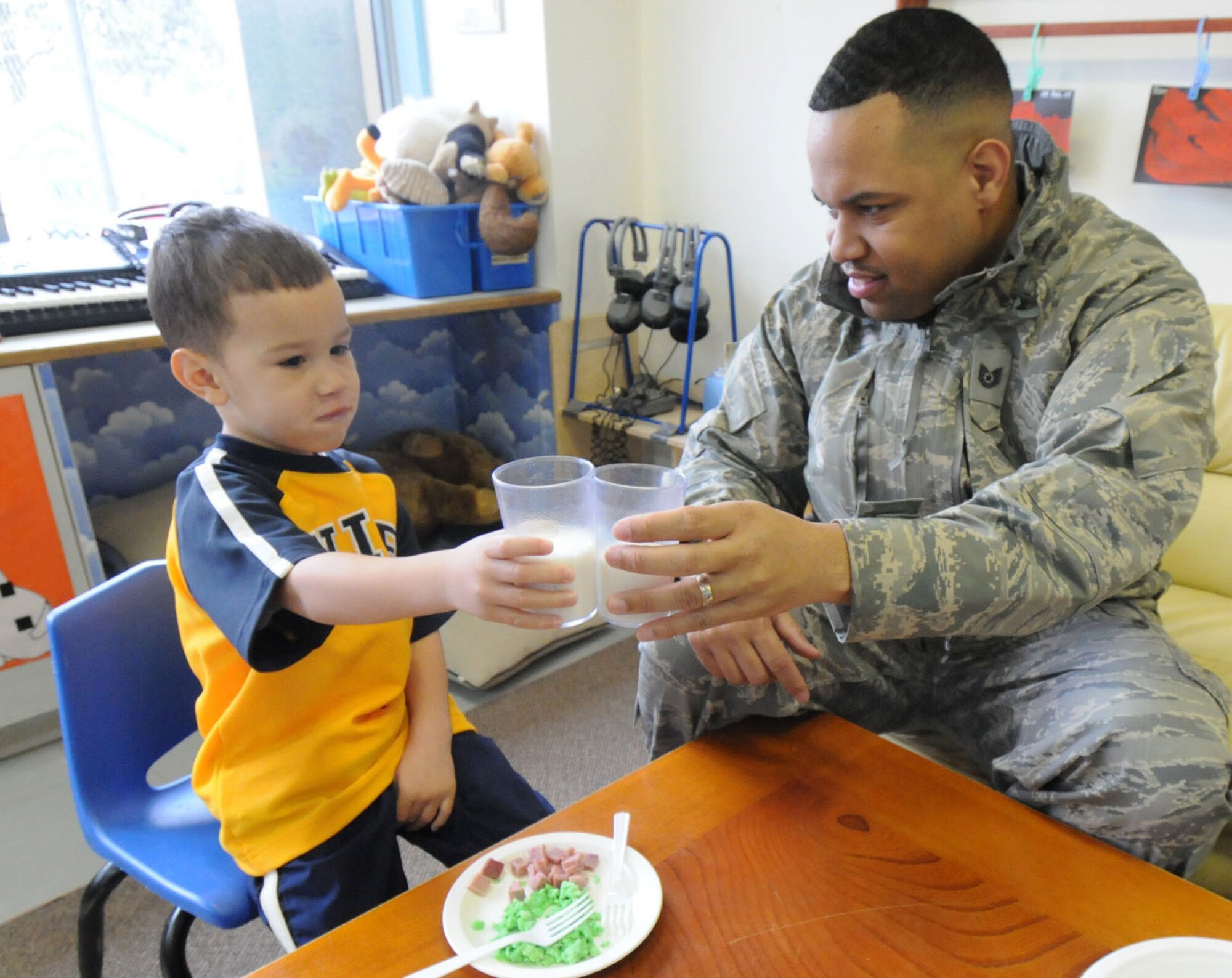 YOKOTA AIR BASE, Japan -- Tech. Sgt. Andrew Yates, 374th Airlift Wing Protocol Office, and son Isaac, make a toast while eating a breakfast of green eggs and ham March 3 at the Yume Child Development Center. Yokota's child development centers invited parents to eat breakfast with their children to celebrate Dr. Seuss' birthday as part of the National Education Association's "Read Across America" program. Dr. Seuss is the pen name of Theodore Seuss Geisel, an American writer and cartoonist who published more than 60 children's books, including the bestsellers "Green Eggs and Ham" and "The Cat in the Hat." (U.S. Air Force photo/Senior Airman Veronica Pierce)