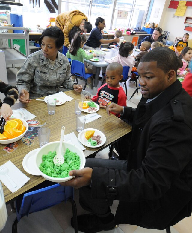 YOKOTA AIR BASE, Japan -- Capt. Tameka Alderman, 374th Airlift Wing, joins her son Aiden-Miycal and husband Keon at a breakfast of green eggs and ham March 3 at the Yume Child Development Center. Yokota's child development centers invited parents to eat breakfast with their children to celebrate Dr. Seuss' birthday as part of the National Education Association's "Read Across America" program. Dr. Seuss is the pen name of Theodore Seuss Geisel, an American writer and cartoonist who published more than 60 children's books, including the bestsellers "Green Eggs and Ham" and "The Cat in the Hat." (U.S. Air Force photo/Senior Airman Veronica Pierce)