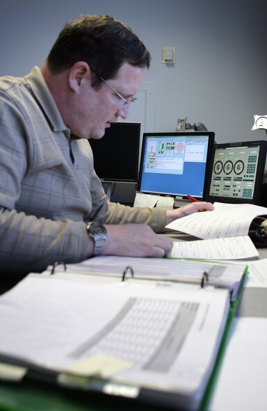 AIR FORCE ACADEMY, Colo. -- Richard Kalber, an observer with the 306th Operational Support Squadron weather flight here, performs quality control on an Air Force Form 3813 recently. (Photo by Ryan Hansen)