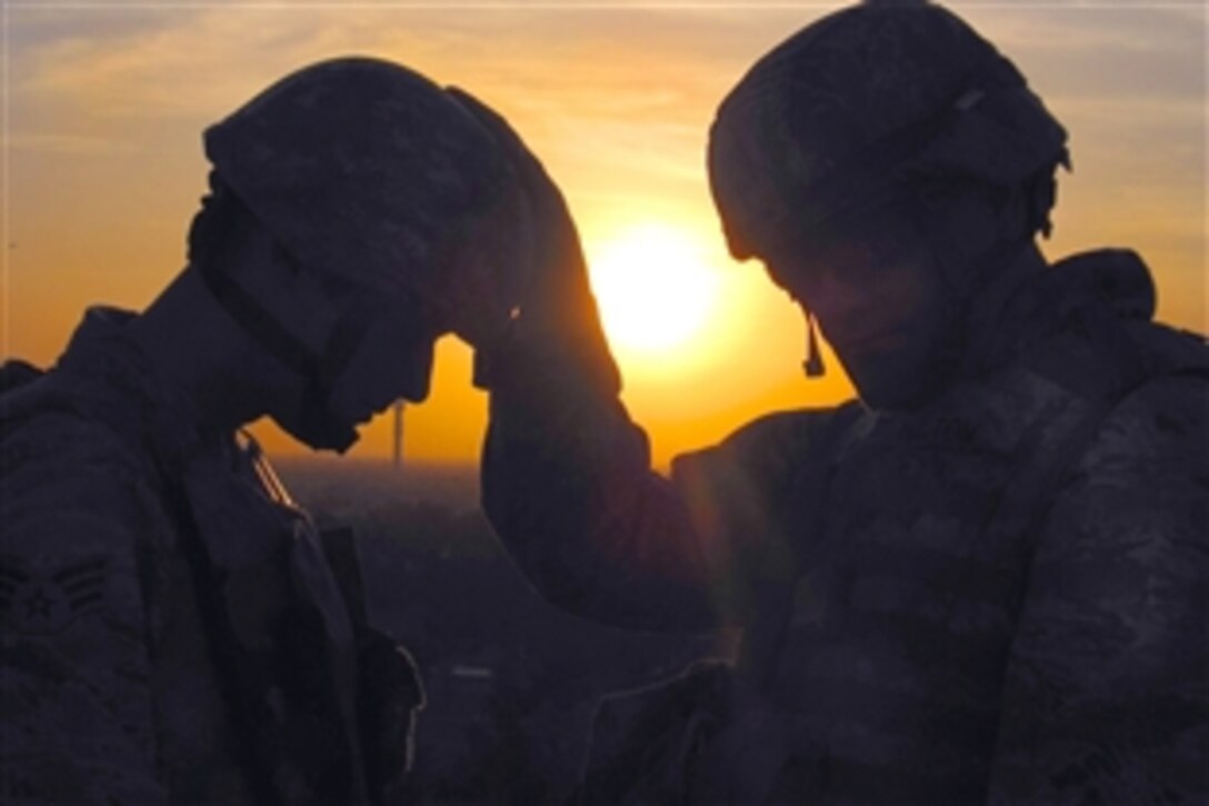U.S. Air Force Capt. David Haltom, a chaplain, provides spiritual guidance to an airman on Balad Air Base, Iraq, March 3, 2009. Chaplains accompany troops during operations around the world and provide them with various types of support.