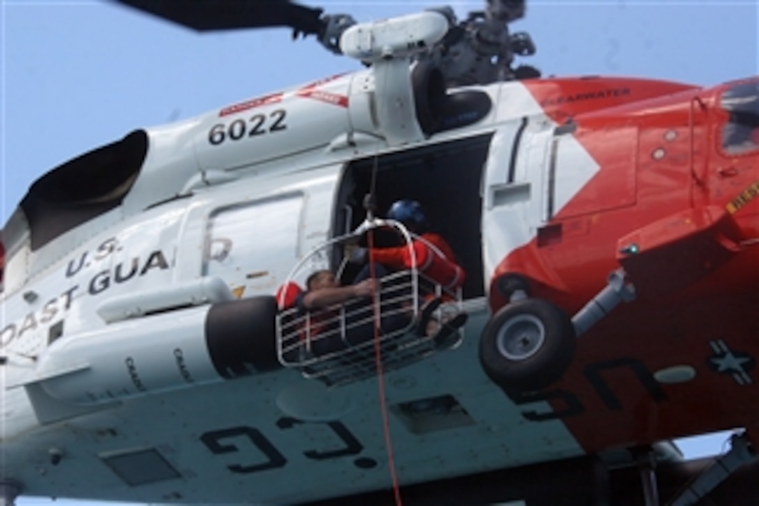 U.S. Coast Guardsmen lift Nick Schuyler from an overturned vessel and into a helicopter 35 miles west of Tampa Bay, Fla., on March 2, 2009.  Rescue operations began when watch standers at Coast Guard Sector St. Petersburg, Fla., were notified March 1 that Schuyler and three friends had not returned from a fishing trip.  The Coast Guardsmen are from U.S. Coast Guard Air Station Clearwater, Fla., and USCGC Tornado (WPC 14).  