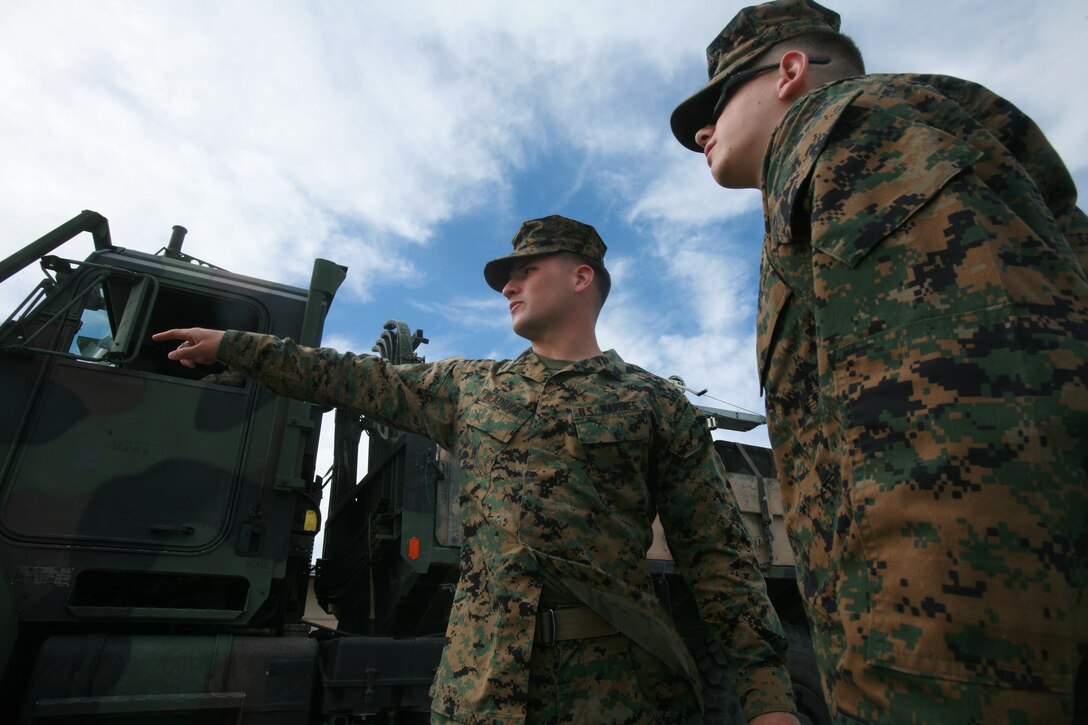 Cpl. Timothy Headrick, 21, Green Bay, Wis., embark noncommissioned officer, Combat Logistics Regiment 17, 1st Marine Logistics Group, points out where to place his equipment here March 3. The devices kept with the embark Marines are going to be used for Mojave Viper training at Marine Corps Air Ground Combat Center Twentynine Palms, Calif.