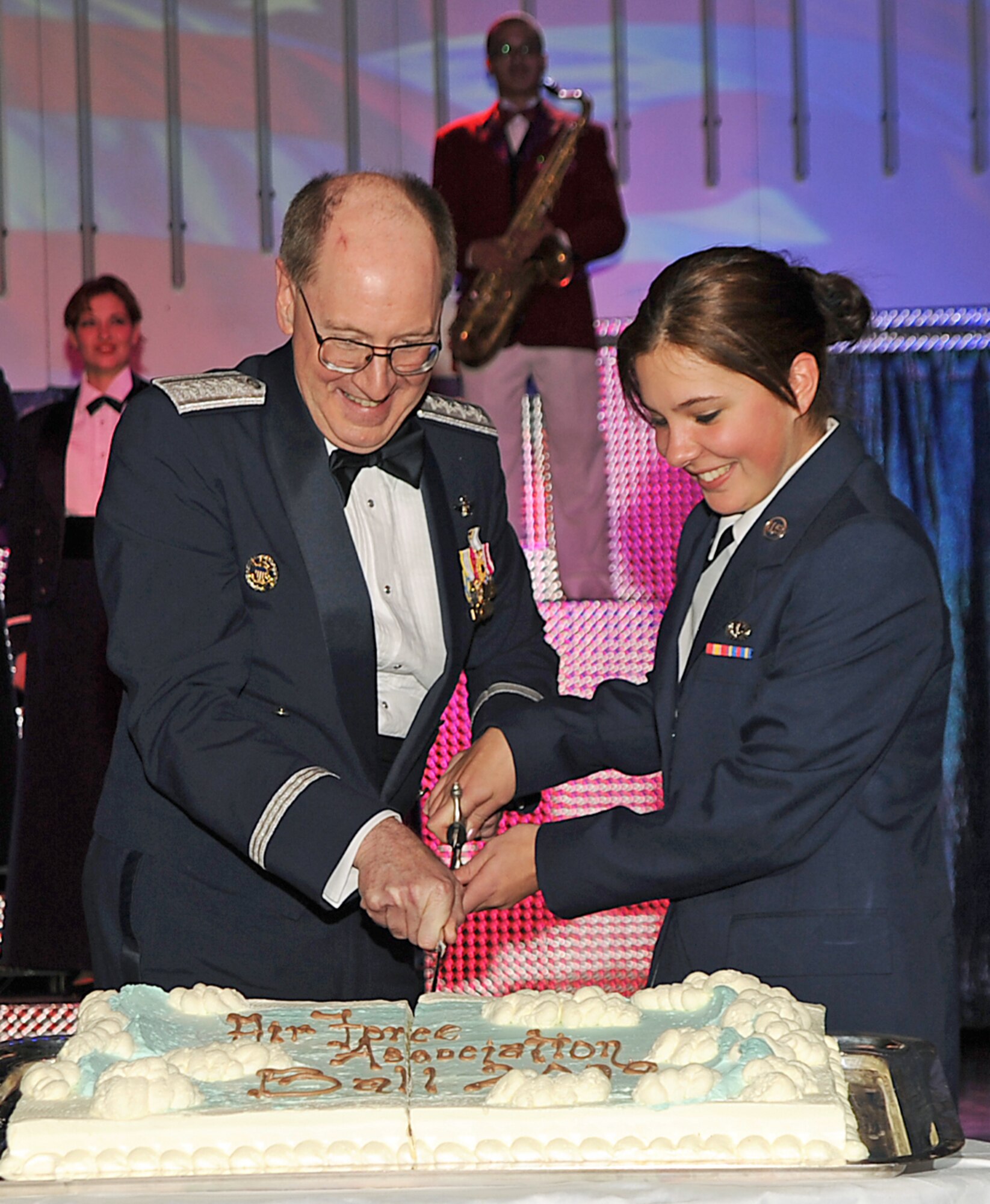 Gen. C. Robert Kehler, Air Force Space Command commander, cuts the cake with the youngest junior Airman, Airman Basic Candace Philippo, of 21st Force Support Squadron, at the Air Force Ball held at the Broadmoor in Colorado Springs Feb. 27.  (Photo by Tech. Sgt. Matthew Lohr)