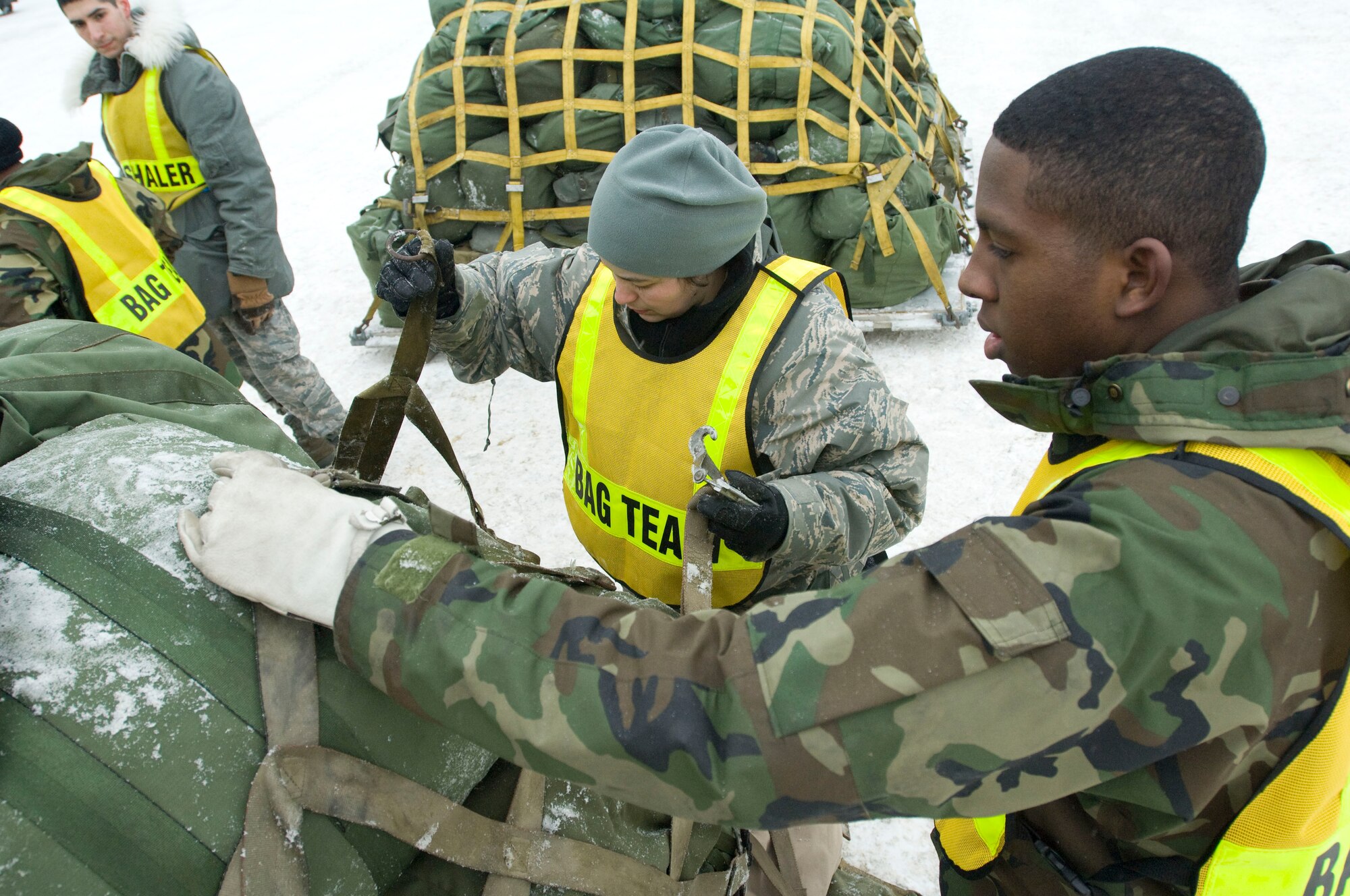 ELMENDORF AIR FORCE BASE, Alaska -- Tech Sgt. Teresa Petrosky, 3rd Medical Operations Squadron, and Airman 1st Class Darren Edem, 3rd Logistics Readiness Squadron, straps down duffle bags for a deployment during an exercise March 3, 2009. The 3rd Wing is exercising in preparation to operational readiness inspection. (U.S. Air Force photo by Senior Airman Jonathan Steffen)