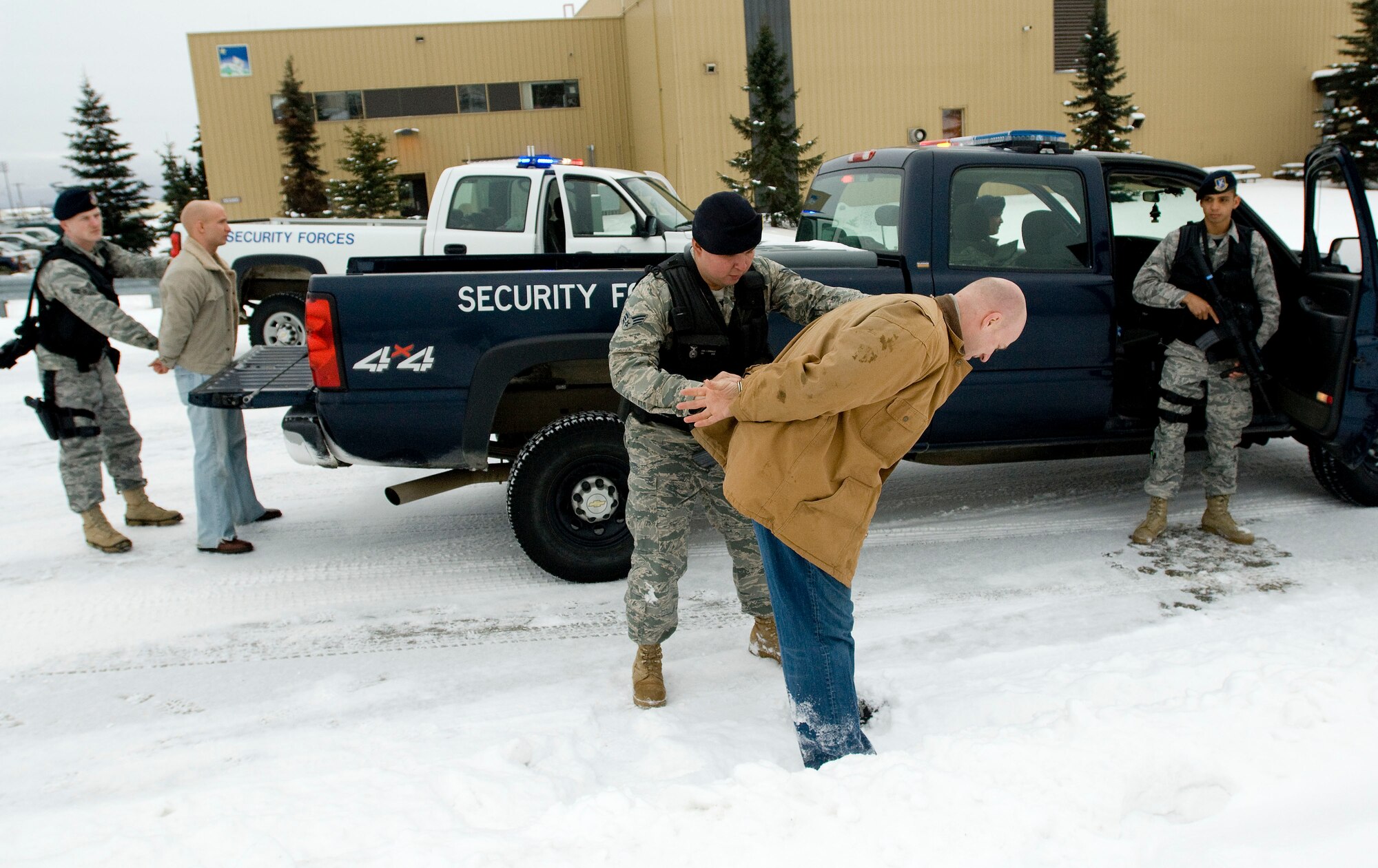 ELMENDORF AIR FORCE BASE, Alaska--Senior Airman Juan Gonzalez, 3rd Security Forces Squadron, secures an intruder that came onto base during an exercise March 3, 2009. The 3rd Wing is exercising in preparation to operational readiness inspection. (U.S. Air Force photo by Senior Airman Jonathan Steffen)