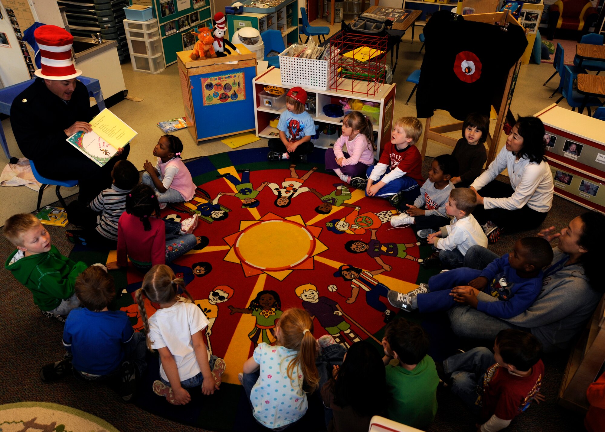 MCCONNELL AIR FORCE BASE, Kan. -- Lt. Col. George Dietrich, 22nd Logistics Readiness Squadron commander, reads a Dr. Seuss book to children at the child development center, March 2, during the Read Across America day. Colonel Dietrich read to a class of 20 children that included his 3-year-old son, Henry. (Photo by Airman Justin Shelton)