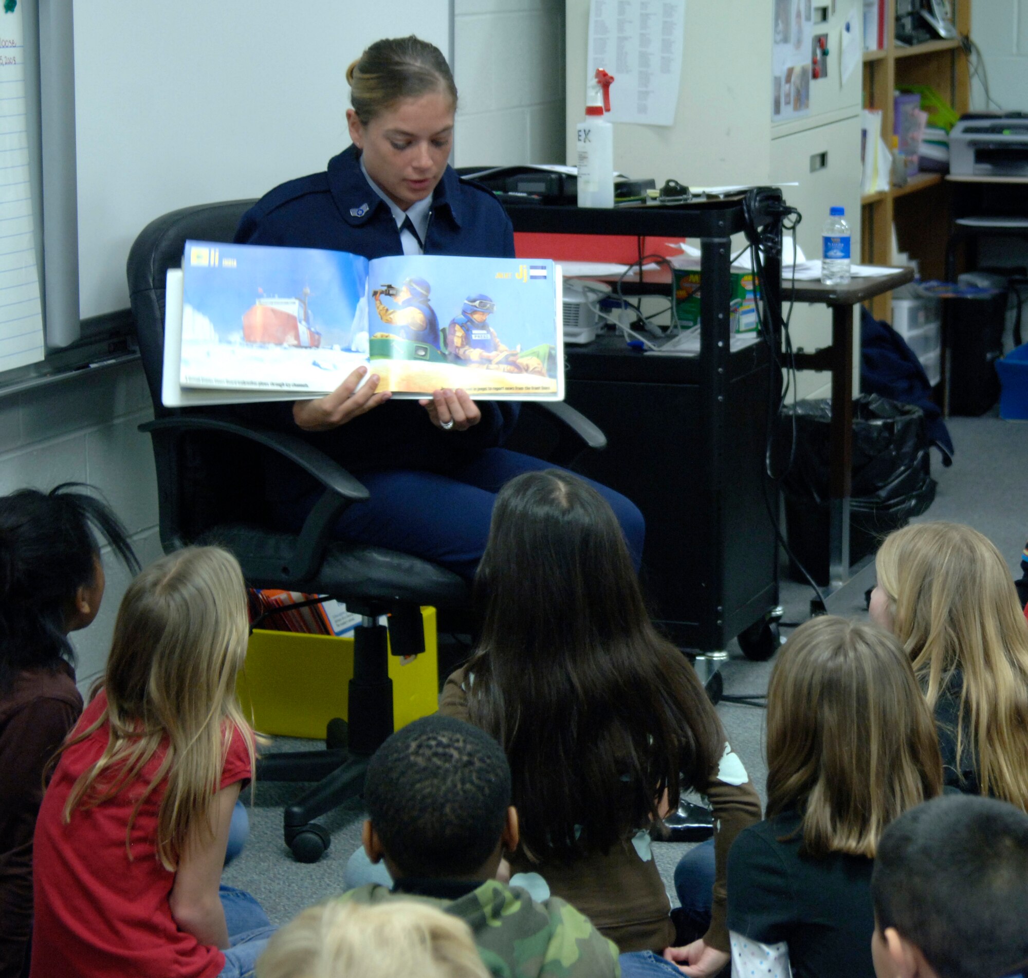 MCCONNELL AIR FORCE BASE, Kan. -- Senior Airman Crystal Wilson, 22nd Air Refueling Wing command post, reads a book to a group of students at Enterprise Elementary School in Wichita during Read Across America day, March 2. Read Across America is a program that addresses literacy in public schools and encourages all children to enjoy reading. (Photo by Senior Airman Laura Suttles)