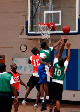 Players attempt to rebound a missed basket during intramural basketball game at the Fitness and Sports Center here March 3. The Army National Guard team defeated the Logistics Readiness Squadron 45-37. (U.S. Air Force photo/Senior Airman Timothy Taylor)