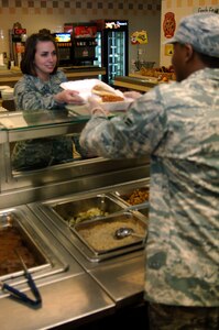 Airman 1st Class Crystal Housman gets take-out at the dining facility here March 4. The newly reinstated take-out service provides Airmen another option when they do not have time to eat at the dining facility. Airman Houseman is with the 437th Comptroller Squadron. (U.S. Air Force photo/Senior Airman Timothy Taylor)