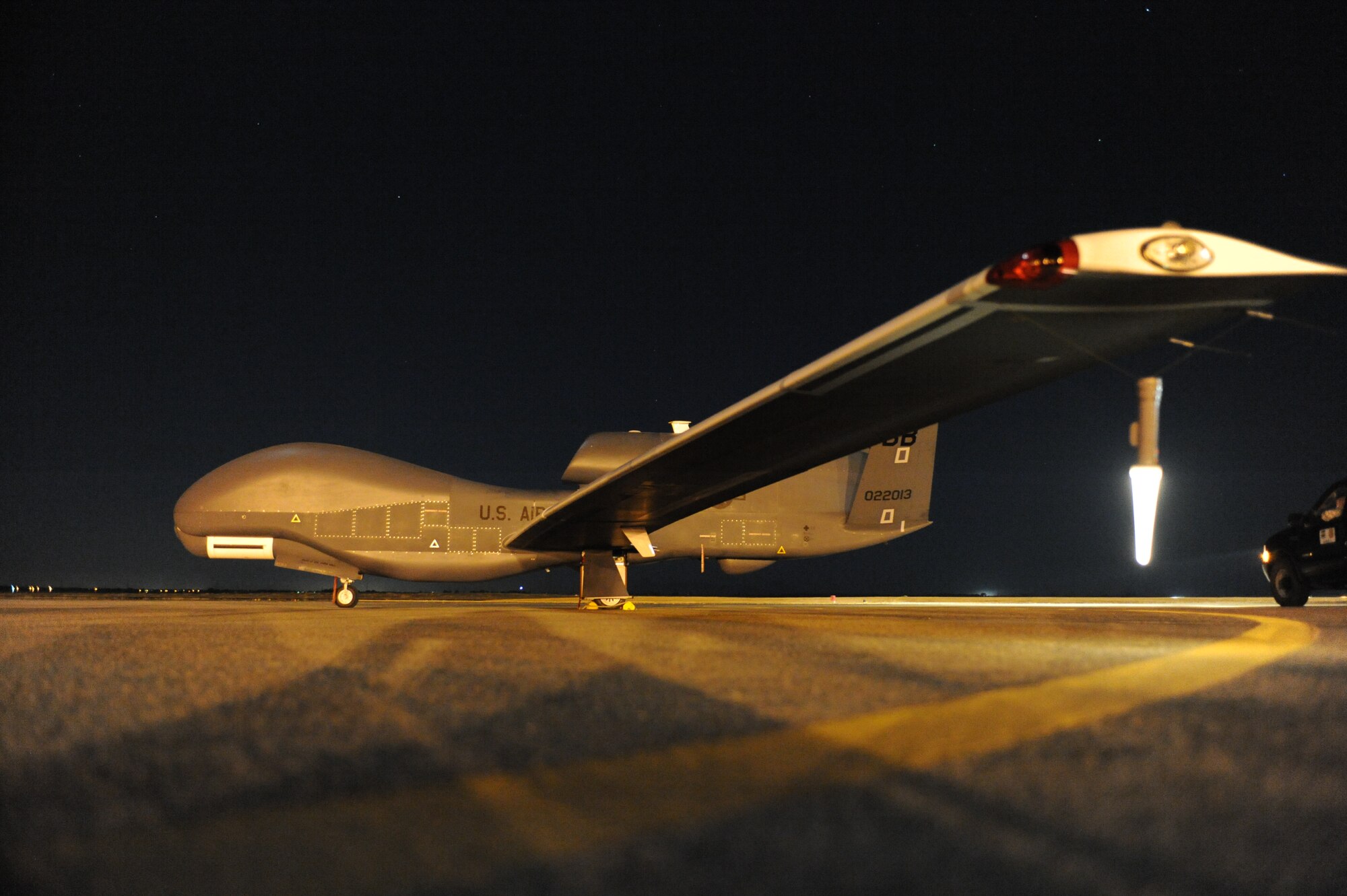 A Global Hawk sits on the runway before beginning a nighttime mission. The aircraft is unmanned, and is used to capture imagery from high-altitudes. (Photo by John Schwab)