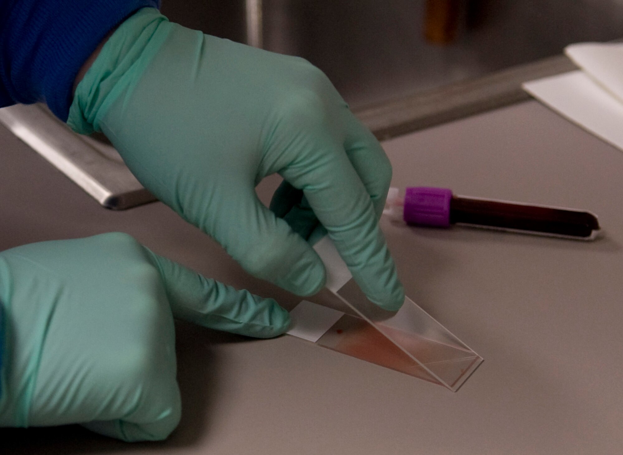 Staff Sgt. Toni Thompson, 354th Medical Group clinical lab technician, prepares a slide March 4, 2009, Eielson Air Force Base, Alaska. Specimens are made into peripheral smears to be examined under a microscope for different diseases. (U.S. Air Force photo/Airman 1st Class Laura Max)