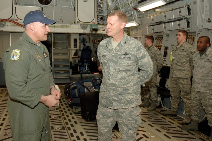 Brig. Gen. Kenneth Merchant prepares to hand Col. John "Red" Millander the keys to Charleston AFB's newest C-17 March 3. The P-184 C-17 is the fourth of 10 new aircraft Charleston Air Force Base is scheduled to receive this year. General Merchant is the director of logistics for Air Mobility Command. Colonel Millander is the 437th Airlift Wing commander.  (U.S. Air Force photo/Staff Sgt. Marie Cassetty) 