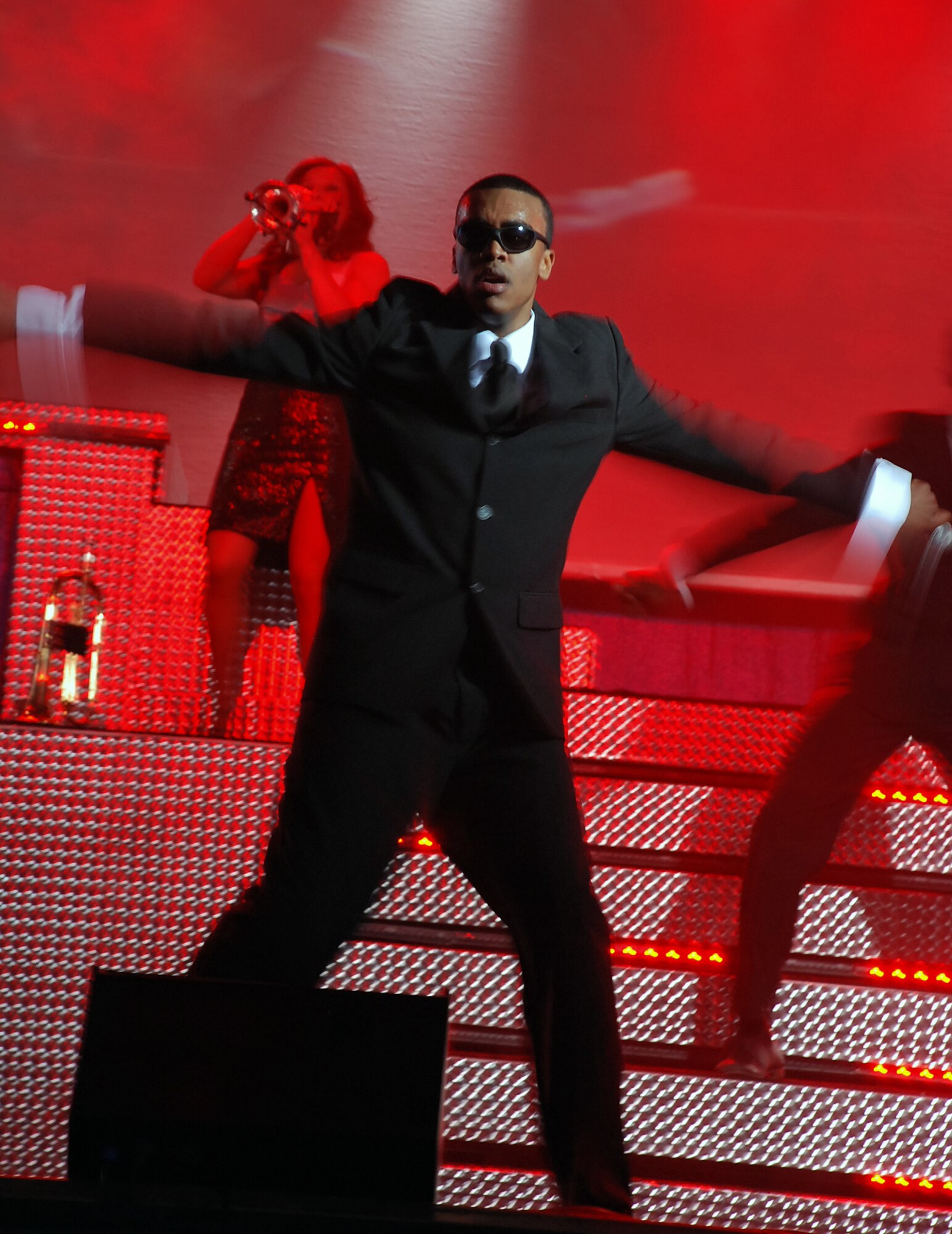 LAUGHLIN AIR FORCE BASE, Texas –Airman 1st Class Barry Smith, Tops in Blue vocalist, performs a song from the Men in Black movie during the Tops in Blue performance inside the T-6 Weather Shelter here Feb. 25. The Air Forces leading entertainment group comprised of 37 active-duty members performed for nearly 600 Laughlin members as a part of their 10 month 2008-2009 World Tour titled “Deja Blue.”(U.S. Air Force photo by Airman 1st Class Sara Csurilla)