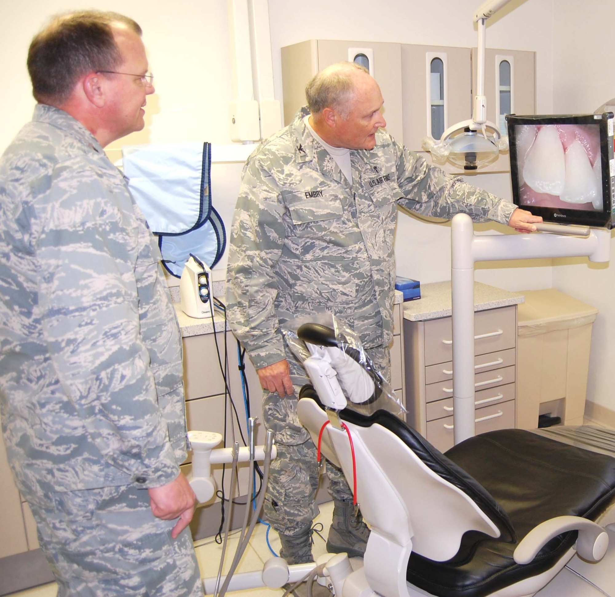 Maj. Gen. (Dr.) Charles Green, left, deputy Air Force surgeon general, listens as Col. (Dr.) John Embry, 81st Dental Squadron commander, explains a digital photograph taken with an intra-oral camera during the general’s Feb. 13 visit to 81st Medical Group facilities.  The recently-installed state-of-the-art equipment allows the patient to see what the dentist is seeing.  General Green also visited the simulation lab, radiation/oncology facilities, emergency department, family health clinic and the Triangle clinic and was briefed about medical training programs.  (U.S. Air Force photo by Steve Pivnick)
