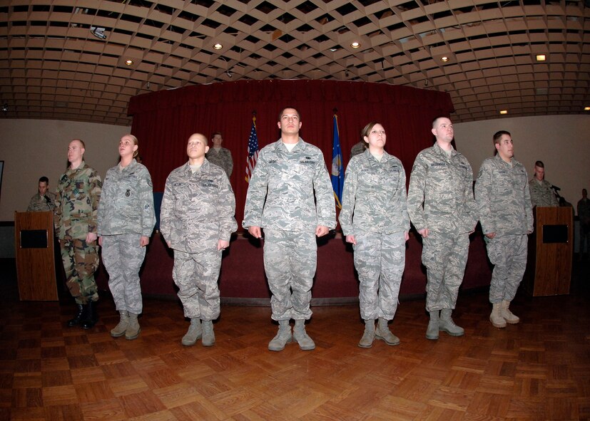 Newly promoted staff sergeants stand at attention as their duties are read off to them before they take their oath of enlistment during the promotion ceremony at Club Fairchild, Feb. 27. (U.S. Air Force photo / Airman 1st Class Melissa L. Barnett)
