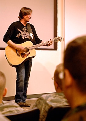 Keni Thomas, a country singer, performs “Not Me”, a song inspired by his former career as an Army Ranger and his survival at the Battle of Mogadishu, at the Survival, Evasion, Resistance and Escape Bud Day Building, Feb 27. Class 09-01 from the 66th Training Squadron and SERE instructors from the 22nd Training Squadron attended the performance. (U.S. Air Force photo / Airman 1st Class Melissa Barnett) 