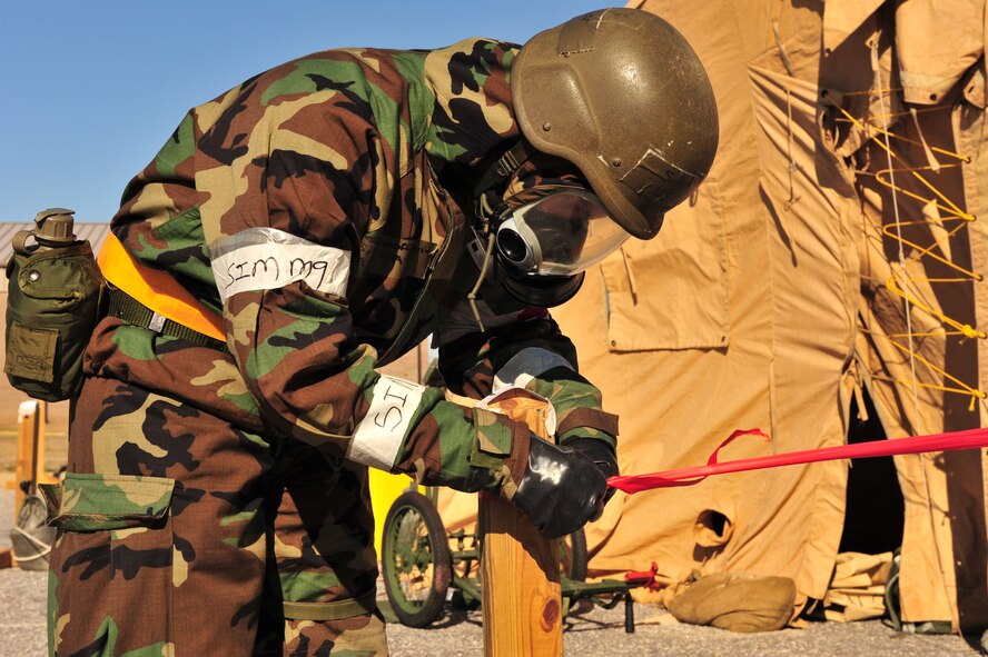 SHAW AIR FORCE BASE, S.C.-- An Airman from the 20th Medical Group puts a cordon around a building where an unexploded object was found on Feb. 23 during a three-day operational readiness exercise.  An operational readiness exercise is a simulated deployment to test Airmen's skills in a combat zone.  (U.S. Air Force Photo by Senior Airman William Coleman)