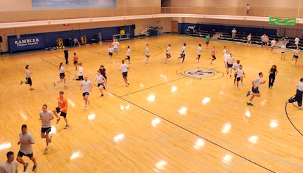Randolph AFB PTLs practice ?butt-kickers? Tuesday afternoon while running through areas separated by cones in the basketball court in the Rambler Fitness Center. (U.S. Air Force photo by Don Lindsey)