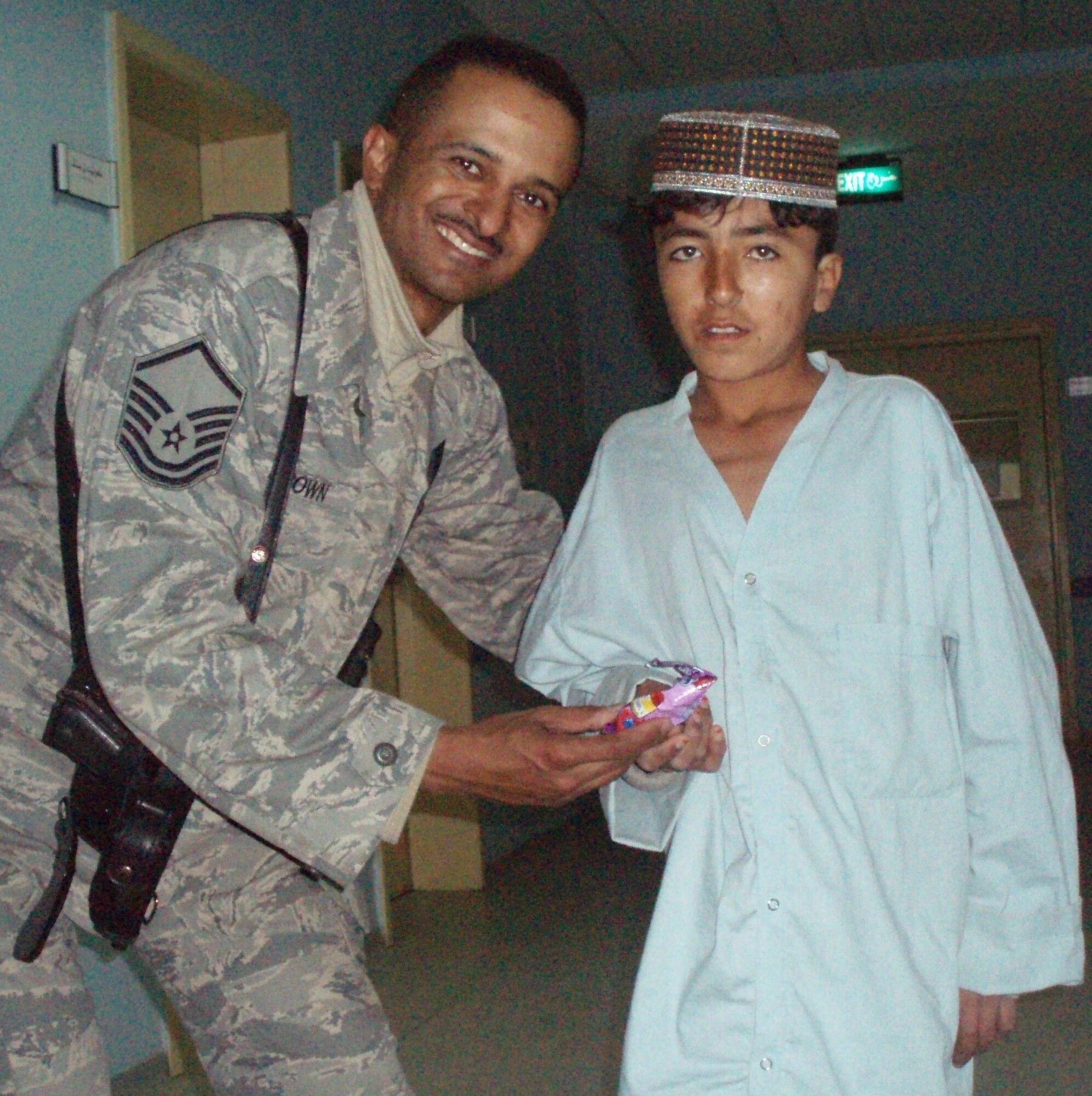 Master Sergeant Dewane Brown, Afghan National Army Medical Embedded Training Team member and combat advisor, visits with a child in an Afghani hospital. Part of Sergeant Brown’s daily duties includes daily interaction with the local populace as he operates outside the wire from a forward operating base. He readily acknowledges his job takes place in a dangerous environment, but he also calls it “one of the most rewarding experiences” of his career. He is scheduled to return to Ellsworth sometime in July. (Courtesy photo by Mr. Doust Mohammed)