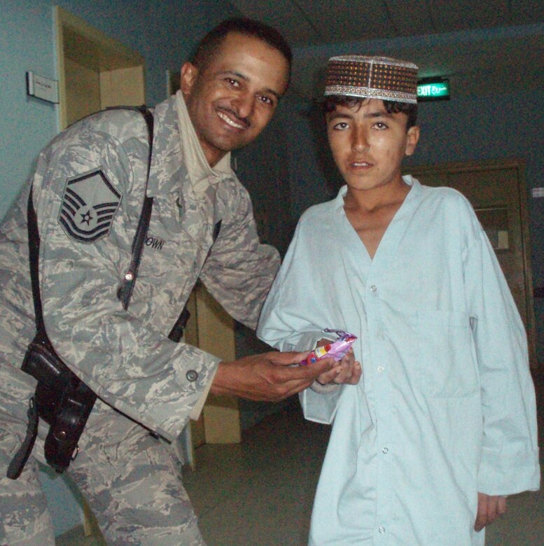 Master Sergeant Dewane Brown, Afghan National Army Medical Embedded Training Team member and combat advisor, visits with a child in an Afghani hospital. Part of Sergeant Brown’s daily duties includes daily interaction with the local populace as he operates outside the wire from a forward operating base. He readily acknowledges his job takes place in a dangerous environment, but he also calls it “one of the most rewarding experiences” of his career. He is scheduled to return to Ellsworth sometime in July. (Courtesy photo by Mr. Doust Mohammed)
