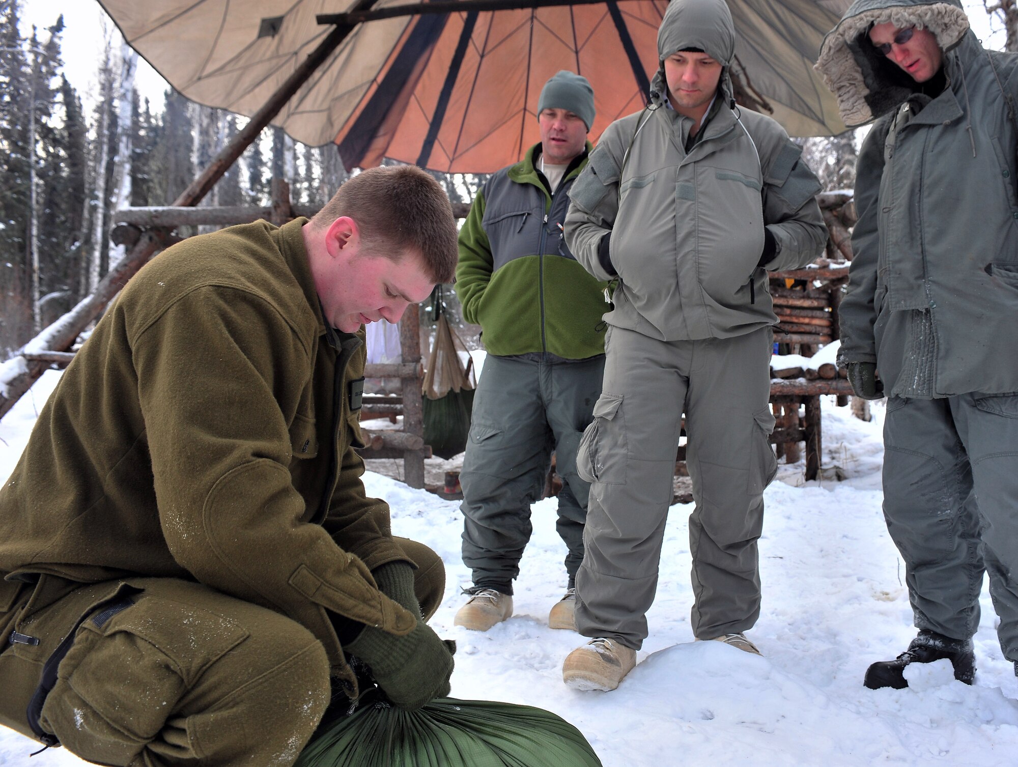 Senior Airman Jess Evans demonstrates making a door plug Feb. 25 at Eielson Air Force Base, Alaska. A door plug is used to insulate the opening of a thermalized A-frame shelter. Airman Evans is an Arctic Survival School instructor. (U.S. Air Force photo/Airman 1st Class Willard E. Grande II) 
