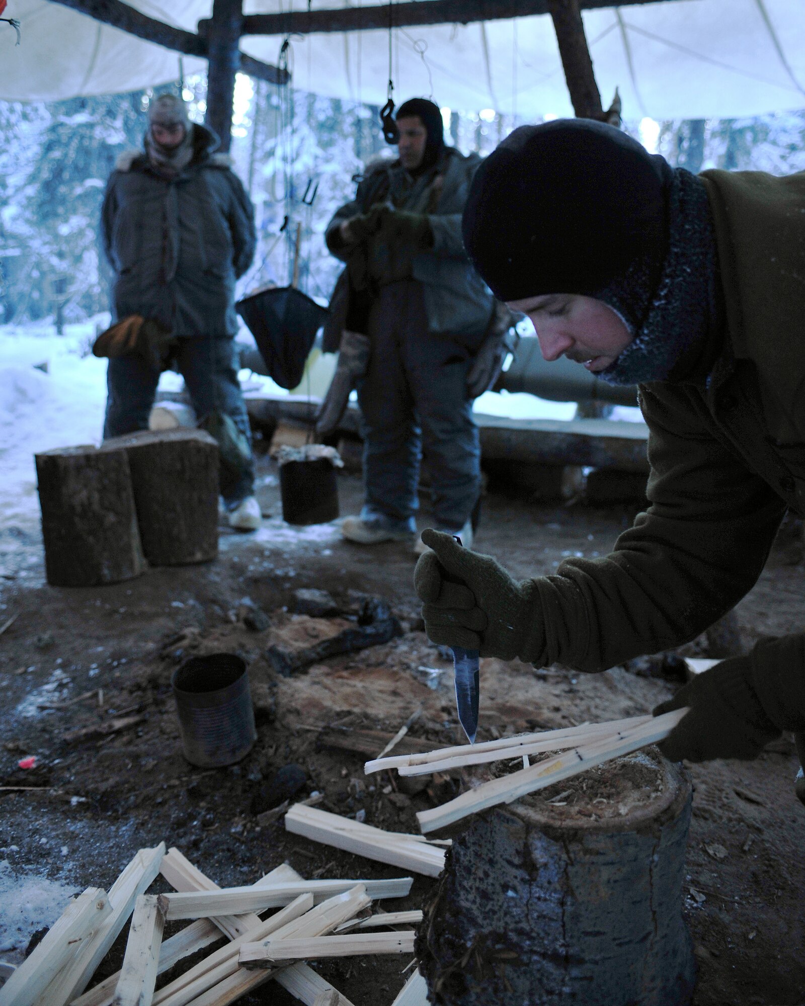 Senior Airman Chris Walsh splits wood Jan. 28 at Eielson Air Force Base, Alaska. The split wood burns faster and makes starting a fire easier than whole logs. Airman Walsh is an Arctic Survival School instructor. (U.S. Air Force photo/Airman 1st Class Willard E. Grande II) 
