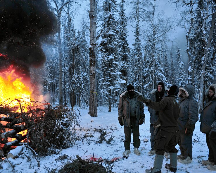 Senior Airman Chris Walsh explains the uses of signal fires Jan. 30 at Eielson Air Force Base, Alaska. Signal fires are one method of signal and recovery and one of the basic survival needs. Airman Walsh is an Arctic Survival School instructor. (U.S. Air Force photo/Airman 1st Class Willard E. Grande II) 