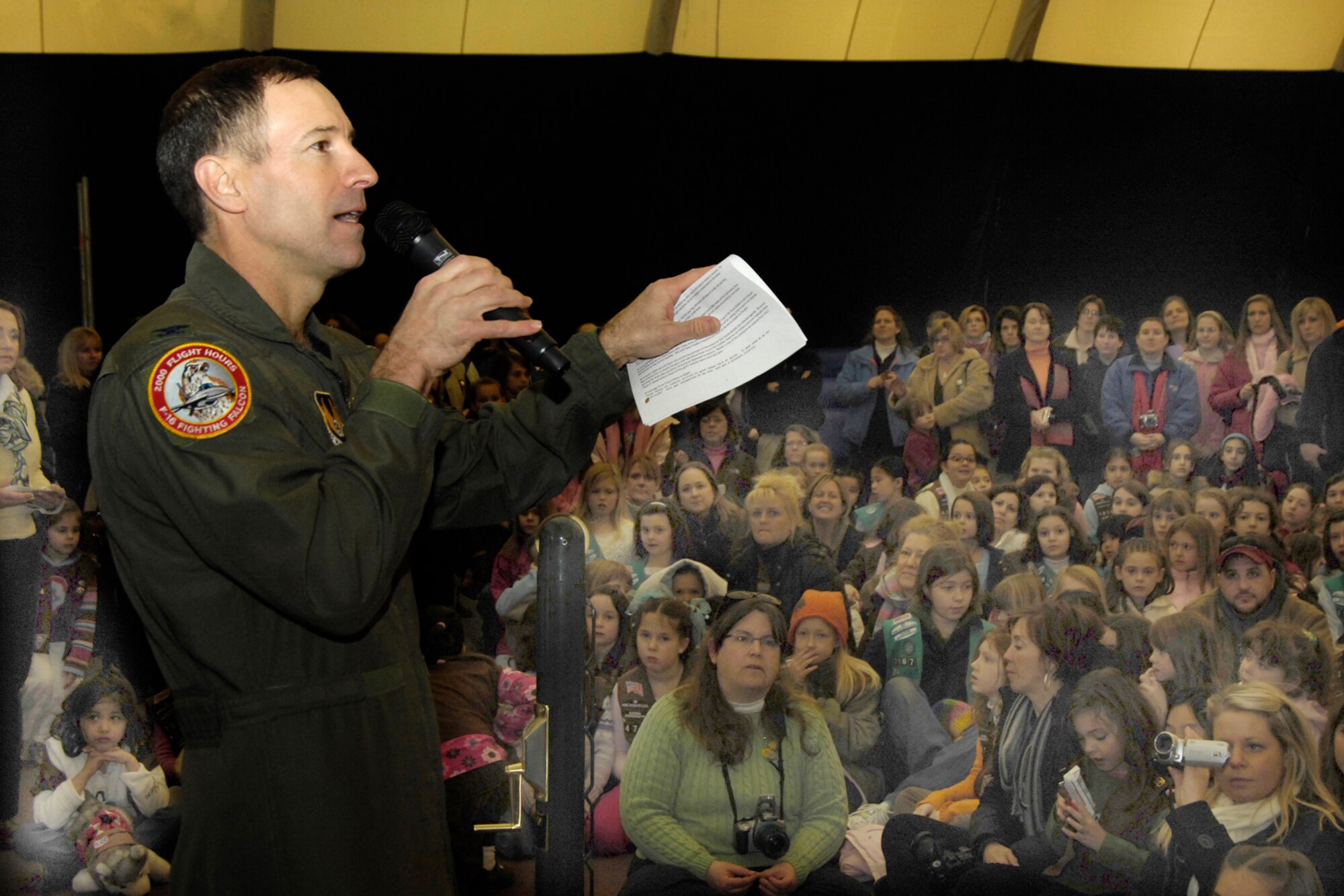 HANSCOM AIR FORCE BASE, Mass. - Col. Dave Orr, 66th Air Base Wing commander, speaks to Girl Scouts gathered at the Tennis Bubble on Feb. 28. More than 1,000 Girl Scouts from across Eastern Massachusetts came to Hanscom to deliver more than 15,000 boxes of cookies that they had collected to be sent to deployed military personnel.  After dropping off their cookies the girls took time to make cards thanking the military personnel for their service. (U.S. Air Force photo by Linda LaBonte Britt)