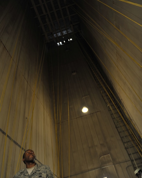 MOODY AIR FORCE BASE, Ga. -- Tech. Sgt. David Edwards, 347th Operations Support Squadron, NCO in-charge of aircrew flight equipment, gives local reporters from the Valdosta Daily Times, a rare glimpse at the drying tower used for parachutes here March 3. Sergeant Edwards conducted the tour through the facility and explained each area of the unit and its importance. (U.S. Air Force photo by Senior Airman Javier Cruz Jr.)