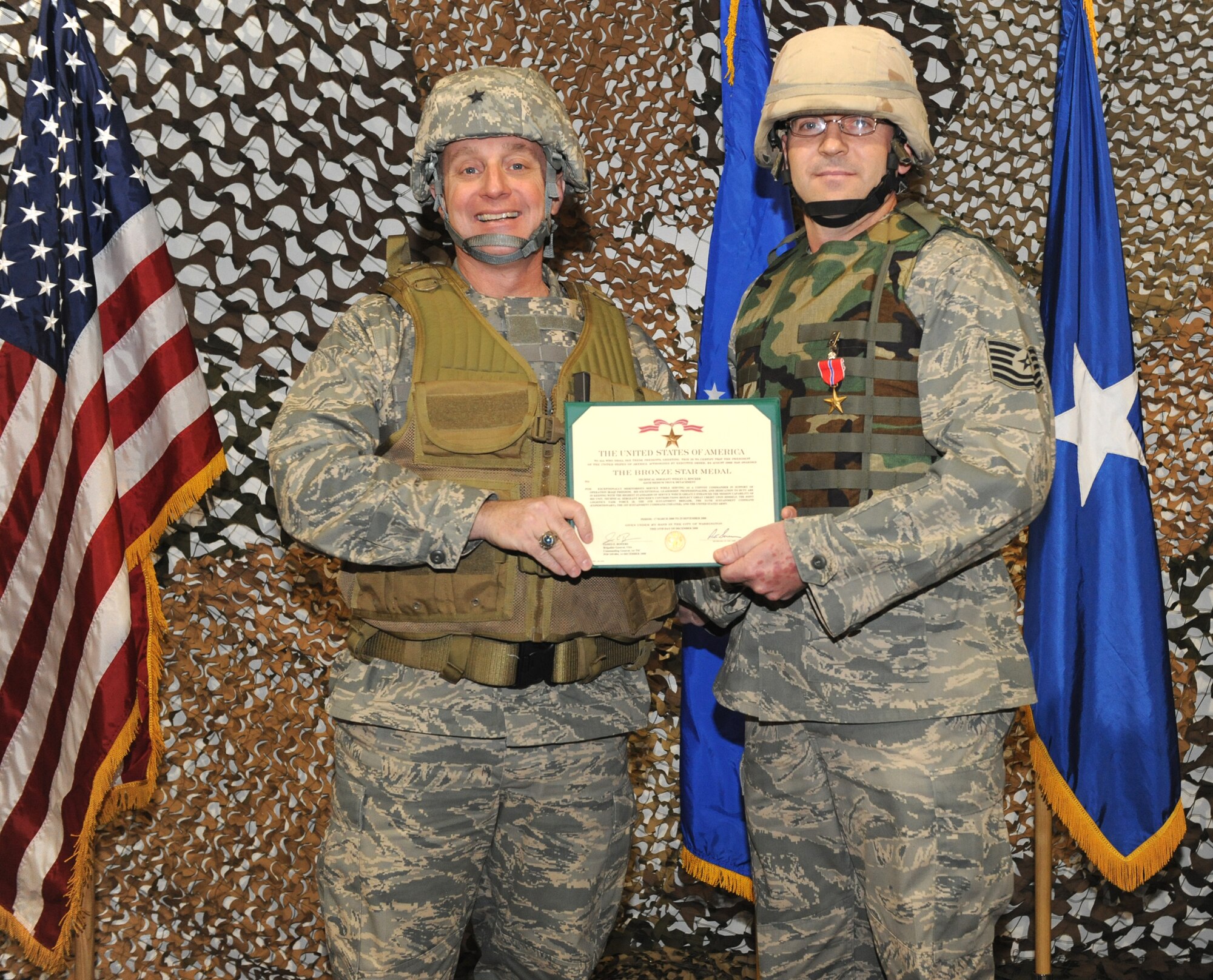 WHITEMAN AIR FORCE BASE, Mo. – Brig. Gen. Garrett Harencak, 509th Bomb Wing commander, presents Tech. Sgt. Wesley Rincker, 509th Logistics Readiness Squadron, with a Bronze Star March 2. Sergeant Rincker completed 18 convoy missions, transporting a total of 22,644 tons of cargo 618,804 miles while he was deployed as the Delta Convoy Commander, Bravo Flight for the 424th Medium Truck Detachment in support of Operation Iraqi Freedom from March 17 to Sept. 25, 2008.  (U.S. Air Force photo/Senior Airman Cory Todd)