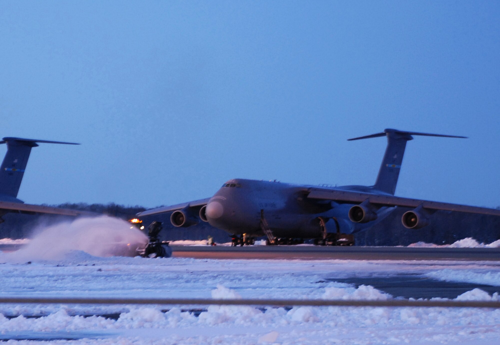 A 436th Civil Engineer Squadron plow clears the flight line of snow March 3. According to the 436th Operations Support Squadron Weather Flight, from the time the snow started falling at about 4:00 p.m. March 1, until it stopped at about 3:00 p.m. March 2, a total of 10.3 inches of snow fell. (U.S. Air Force Photo/2nd Lt. Brian Maguire)