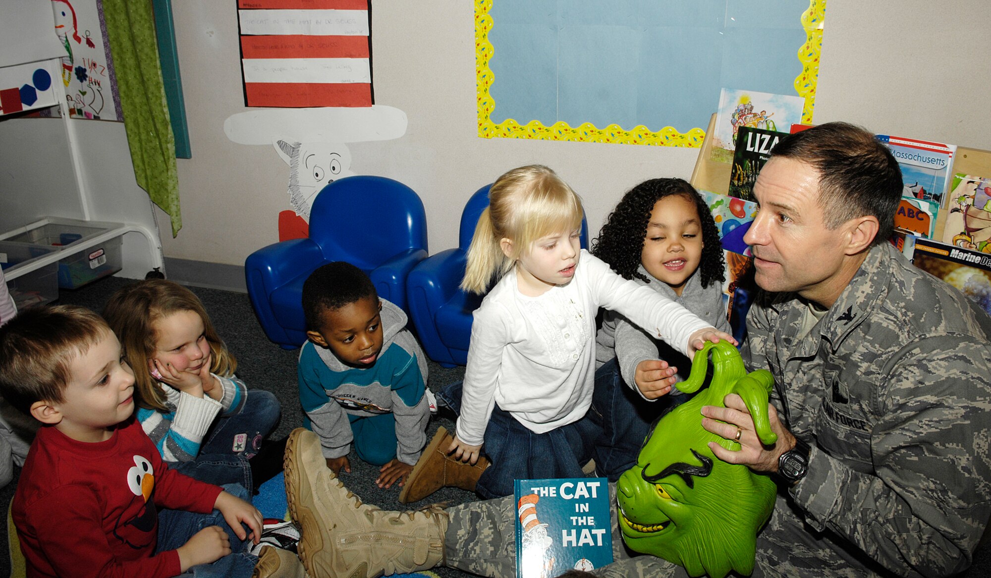 HANSCOM AIR FORCE BASE, Mass. – Col. David Orr, 66th Air Base Wing commander, talks about Dr. Seuss and the Grinch character with (from left to right) Zachary Gilbert, Autumn Reed, Demetre Washington, Kyndal Williamson, and Jahna Rood at the Hanscom Child Development Center on March 2. The CDC is celebrating National Read Across America this week with special activities, events to teach children the importance of reading. (U.S. Air Force photo by Linda LaBonte Britt)