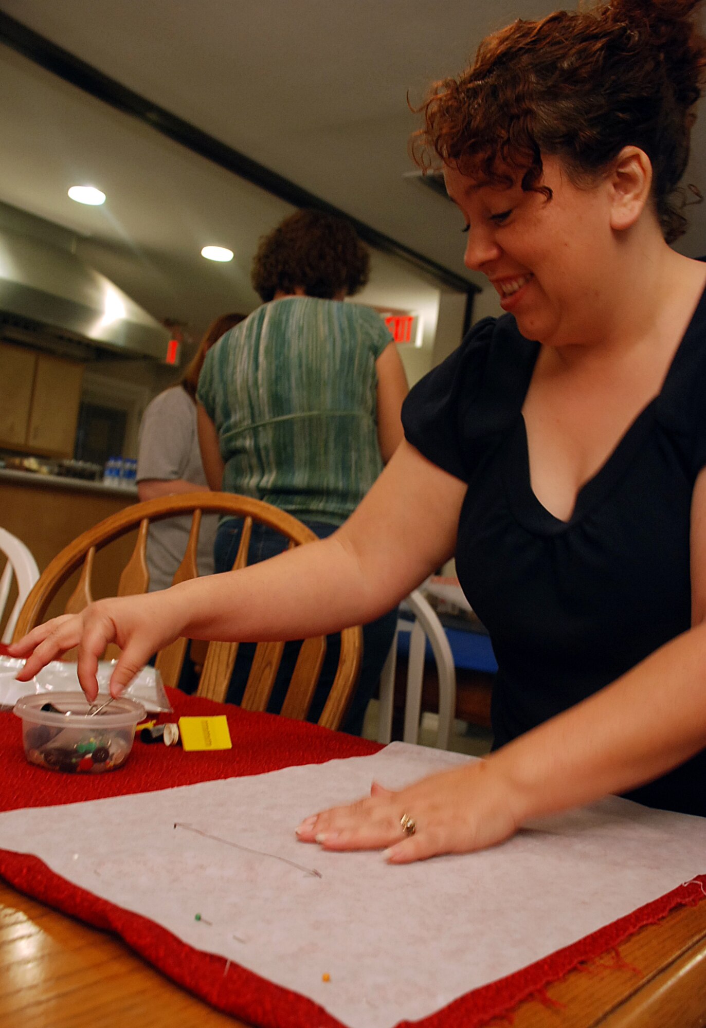 LAUGHLIN AIR FORCE BASE, Texas - Monica Kudrna, Laughlin Enlisted Association president, makes a place mat during the LEA's monthly meeting at Su Casa here Feb. 26. The LEA meetings are open to any enlisted active-duty or retired member and their dependents. "We meet the last Thursday of every month at Su Casa," said Kudrna. "Every time we meet there is a lot of socializing and activities as we bring the enlisted community together. We would love to see more people join our group." (U.S. Air Force photo by Airman 1st Class Sara Csurilla)